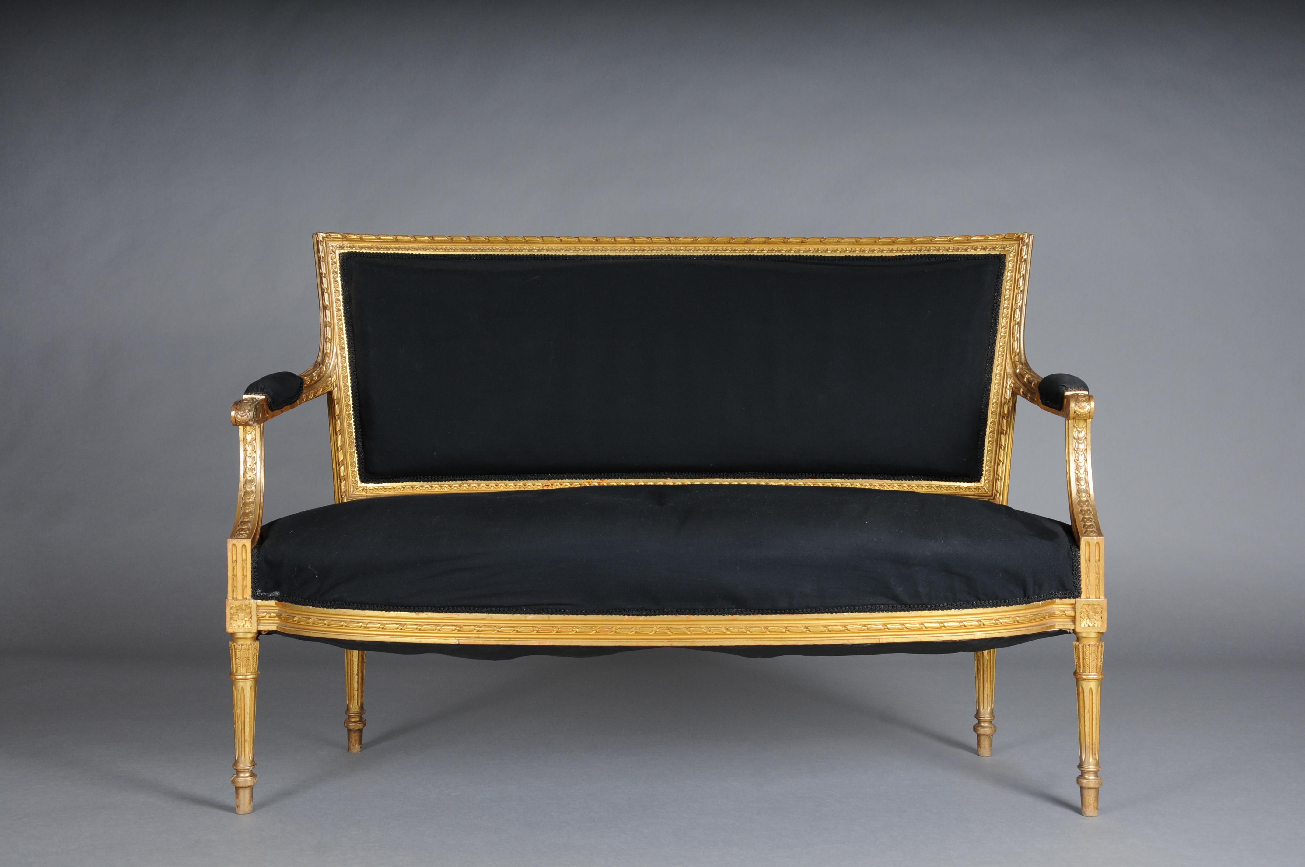 Antique French salon canape/sofa Louis XVI, gold

Solid wood, finely carved and gilded. Channeled and grooved legs. Seat and backrest as well as armrests are padded and covered with black fabric.

France 19th century