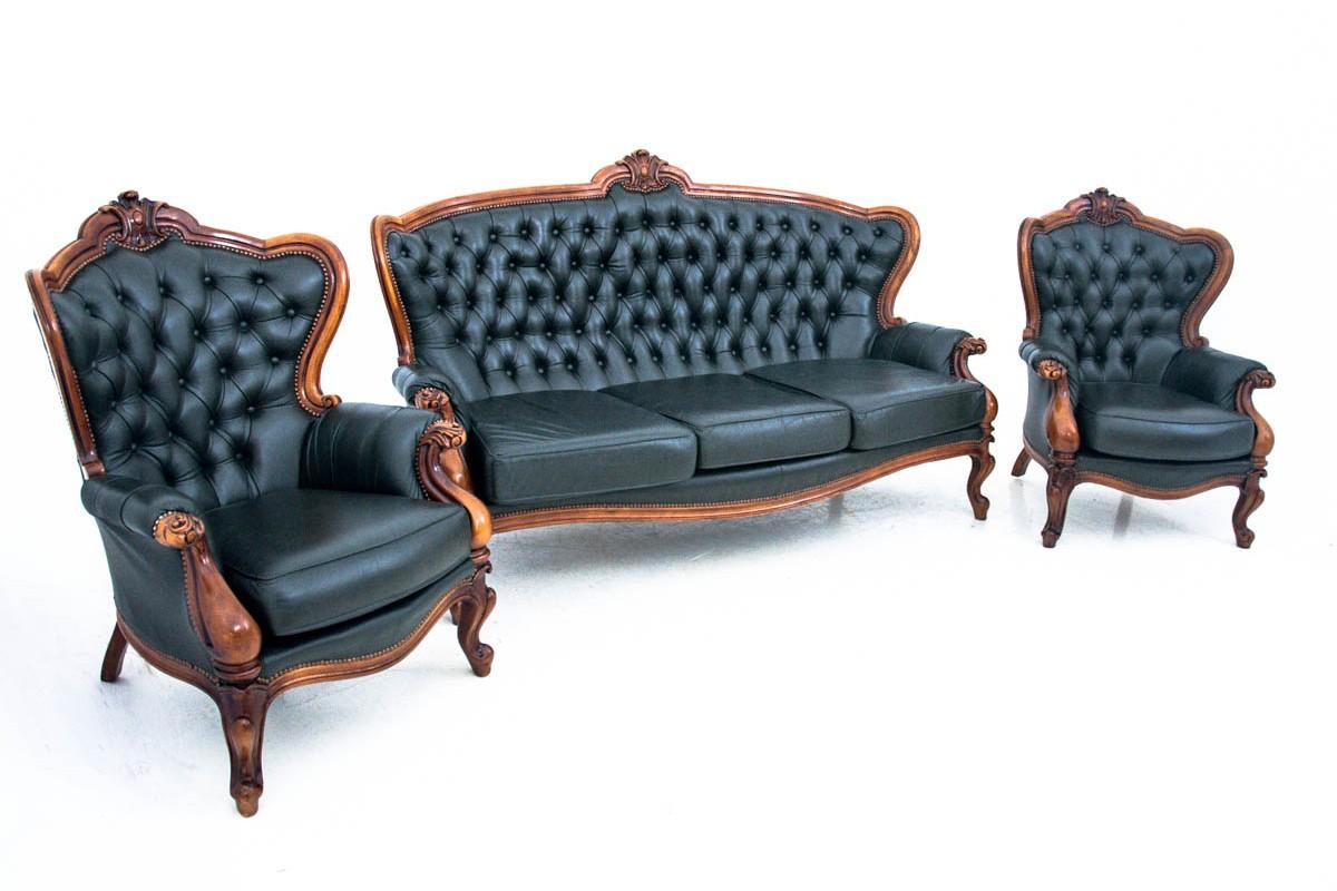Salon set, France, mid-20th century.
Very good condition.
Wood: walnut
Material: black leather 
Dimensions

Sofa: height 108 cm, seat height 46 cm width 192 cm depth 90 cm

Armchairs height 102 cm, seat height 45 cm, width 80 cm, depth 82 cm.