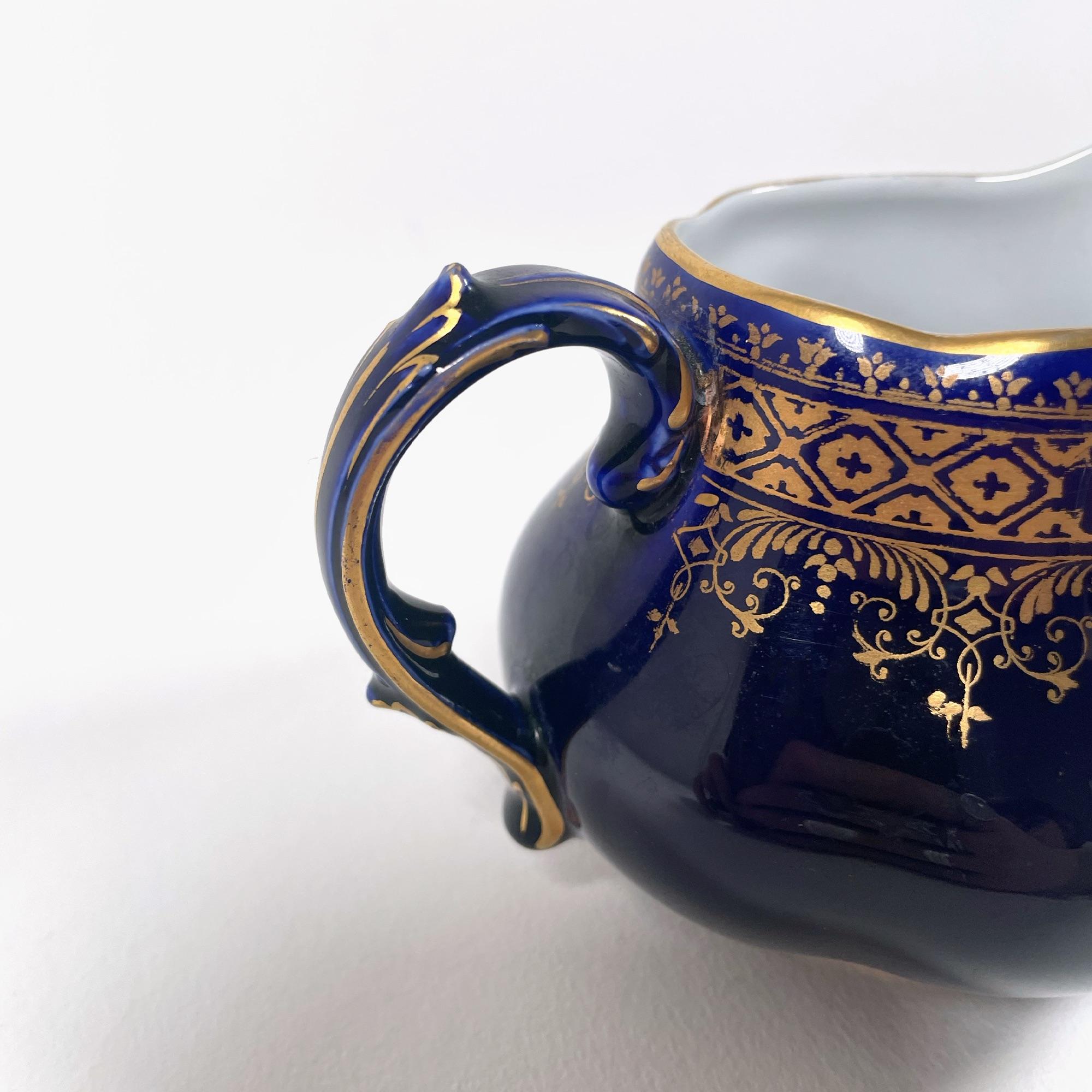 Discover the timeless charm of this antique milk jug, crafted in the early 1900s by the renowned French ceramic maker Sarreguemines. Made of fine faience, this piece is a testament to the exceptional craftsmanship that characterized the brand during