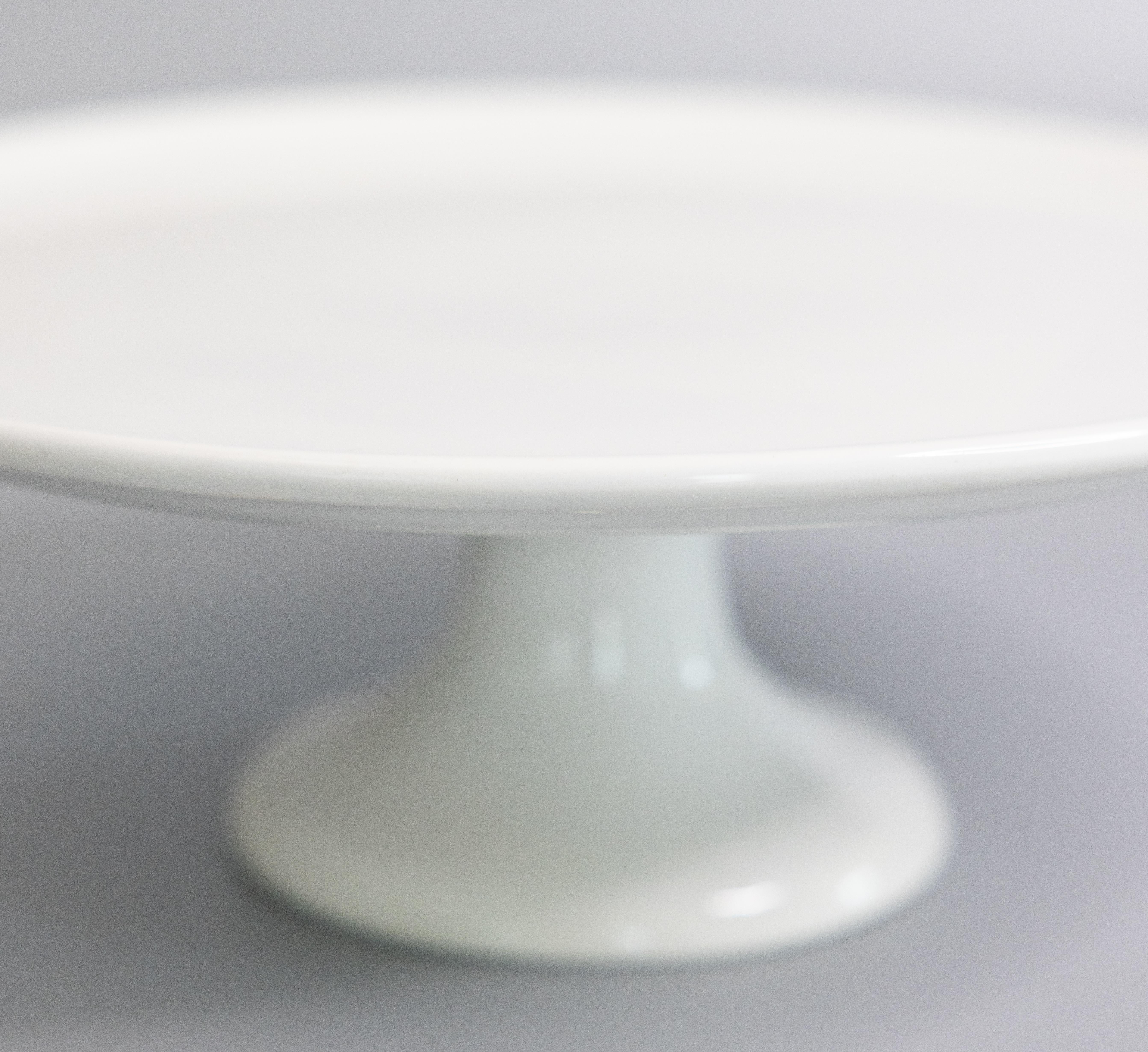 A gorgeous antique white ironstone cake stand on a pedestal made in France, circa 1920. Marked 