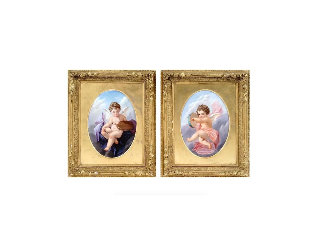 A pair of antique 19th century French porcelain plaques, each of an oval form, beautifully hand painted with Rococo scenes depicting putti or cherubs, seated on clouds, one holding a palette and brushes, and the other playing the tambourine. Both