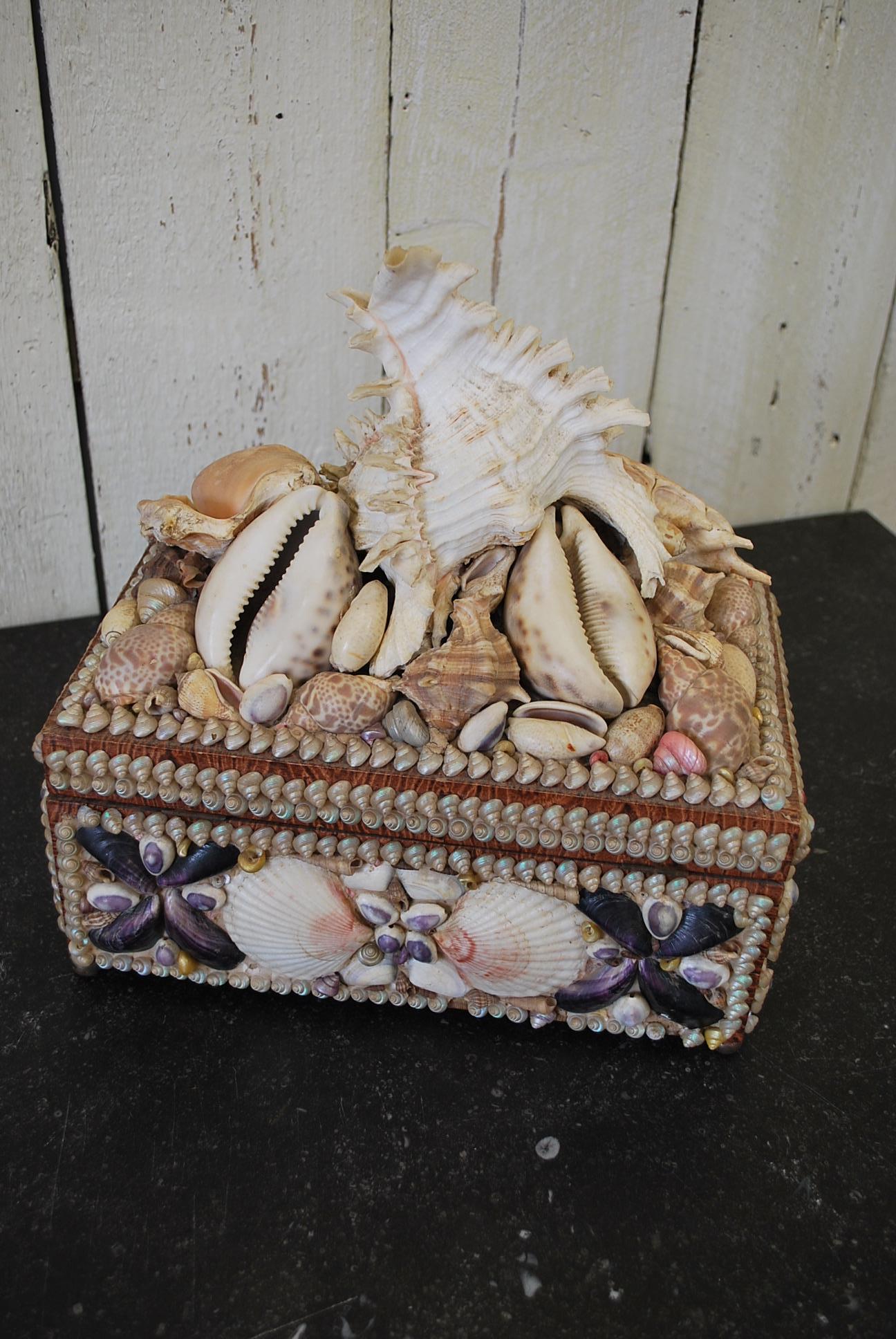 A rare and unusual box decorated on all sides in various kinds of shells as an early souvenir from the early 20th century. Opens to reveal a lined interior with mirror inside the lid, looks fabulous as a decorative piece on the centre of a piece of