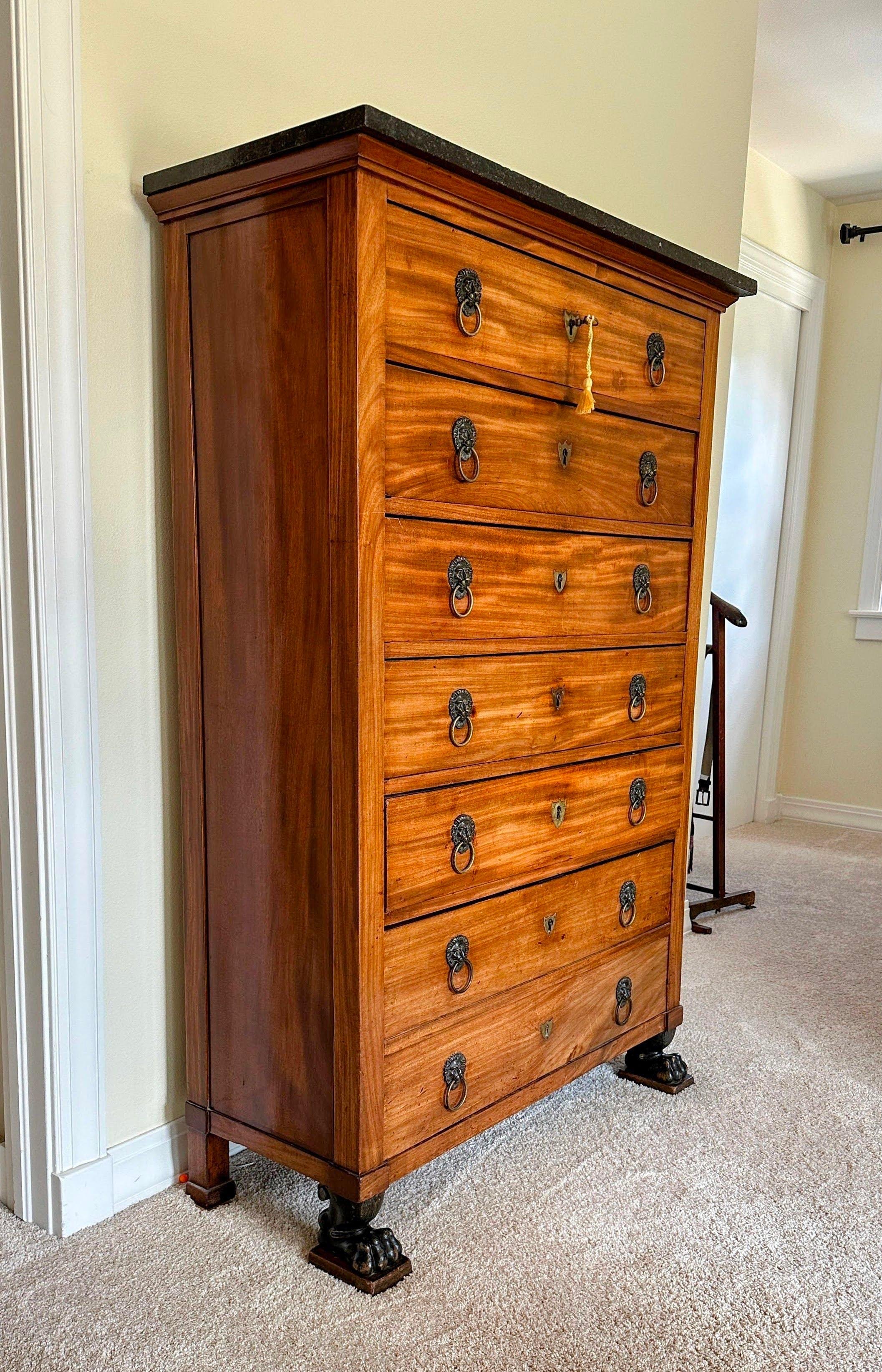 Antique French Semainier Empire Tall Chest of Drawers. A classic early French Empire semainier in walnut, each of the six drawers (double faux drawer on bottom), has a pair of brass lion’s mask door pulls on each drawers, and a fine brass escutcheon
