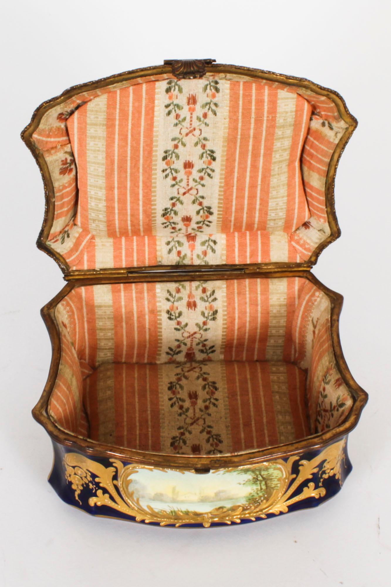 This is a fabulous antique French Sevres ormolu mounted cobalt blue soft paste porcelain  jewellery casket, Circa 1870 in date.

The shaped hinged ormolu mounted cover is superbly decorated with a hand painted courting couple in a richly gilded