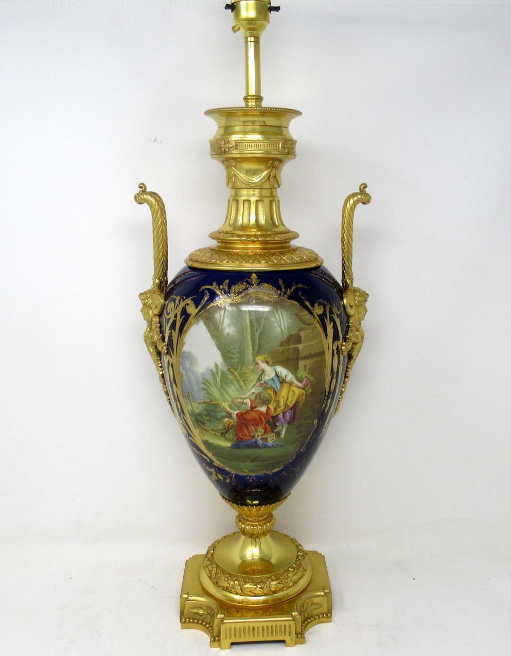 Stunning French Sèvres soft paste porcelain and ormolu twin handle electric table lamp of traditional urn form, and of large size proportions, raised on a square stepped base with ornate canted corners, mid-19th century.

The twin lavish cast