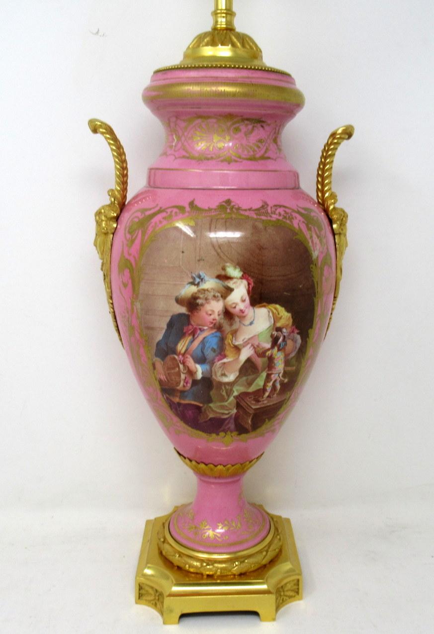 Stunning French Sevres soft paste porcelain and ormolu twin handle electric table lamp of traditional Urn form, and of large size proportions, raised on a square stepped base with ornate canted corners. Mid nineteenth century. 

The twin lavish