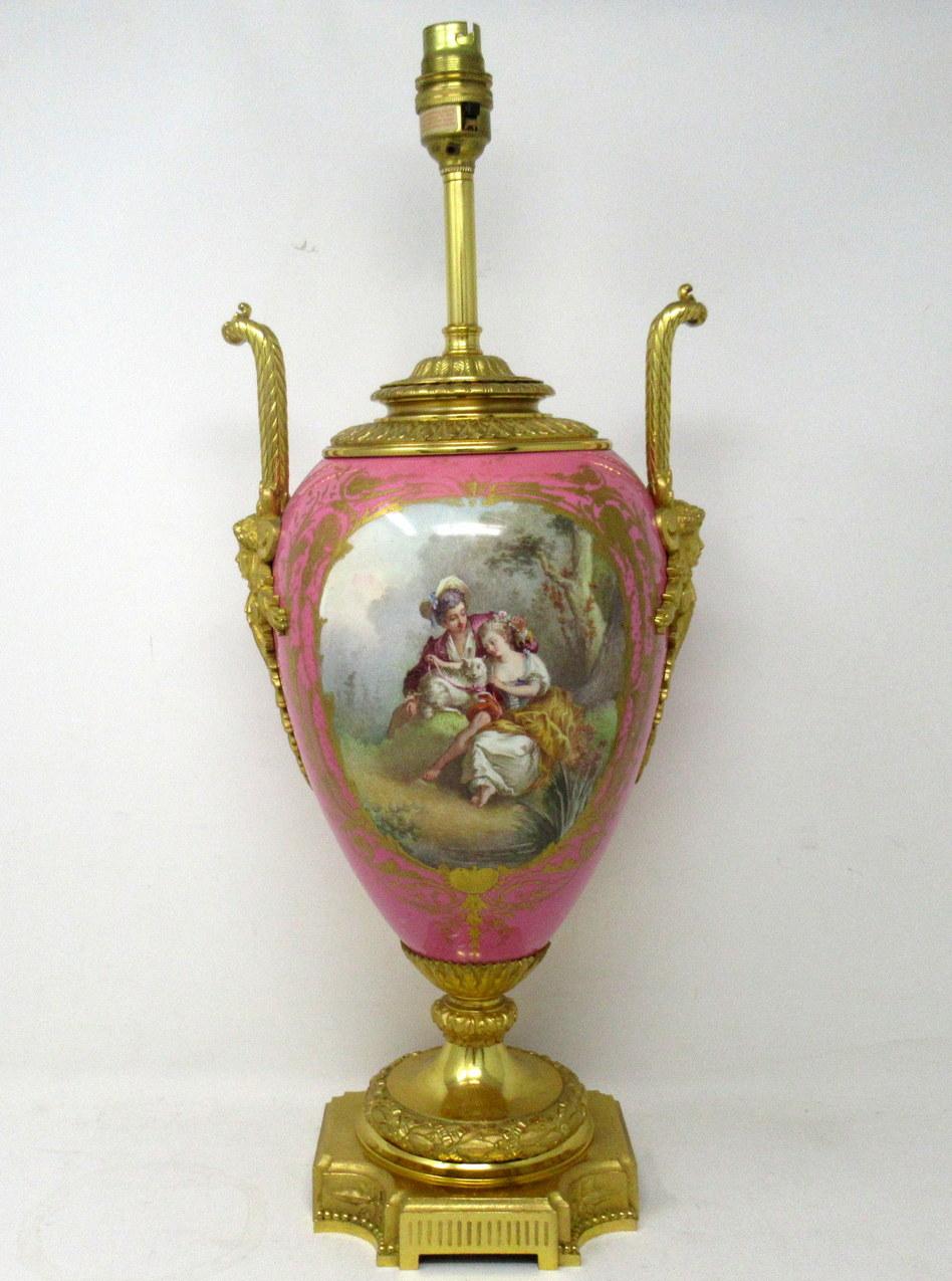 

Stunning French Sevres Soft Paste Porcelain and Ormolu Twin Handle Electric Table Lamp of traditional Urn form, and of large size proportions, raised on a square stepped base with ornate canted corners. Mid Nineteenth Century. 

The twin
