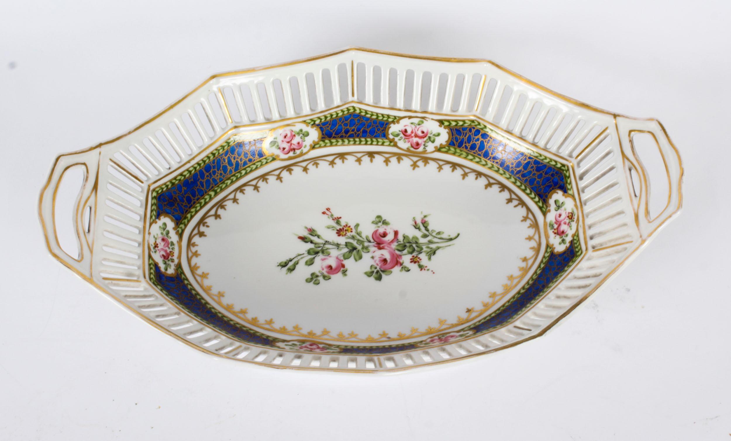 This is a decorative antique French Sevres oval porcelain dish, dating from Circa 1880.

The oval pierced borderwith gilt highlights with a striking Bleu Royal inner border, the centre masterfully hand painted with flowers, the border interspersed