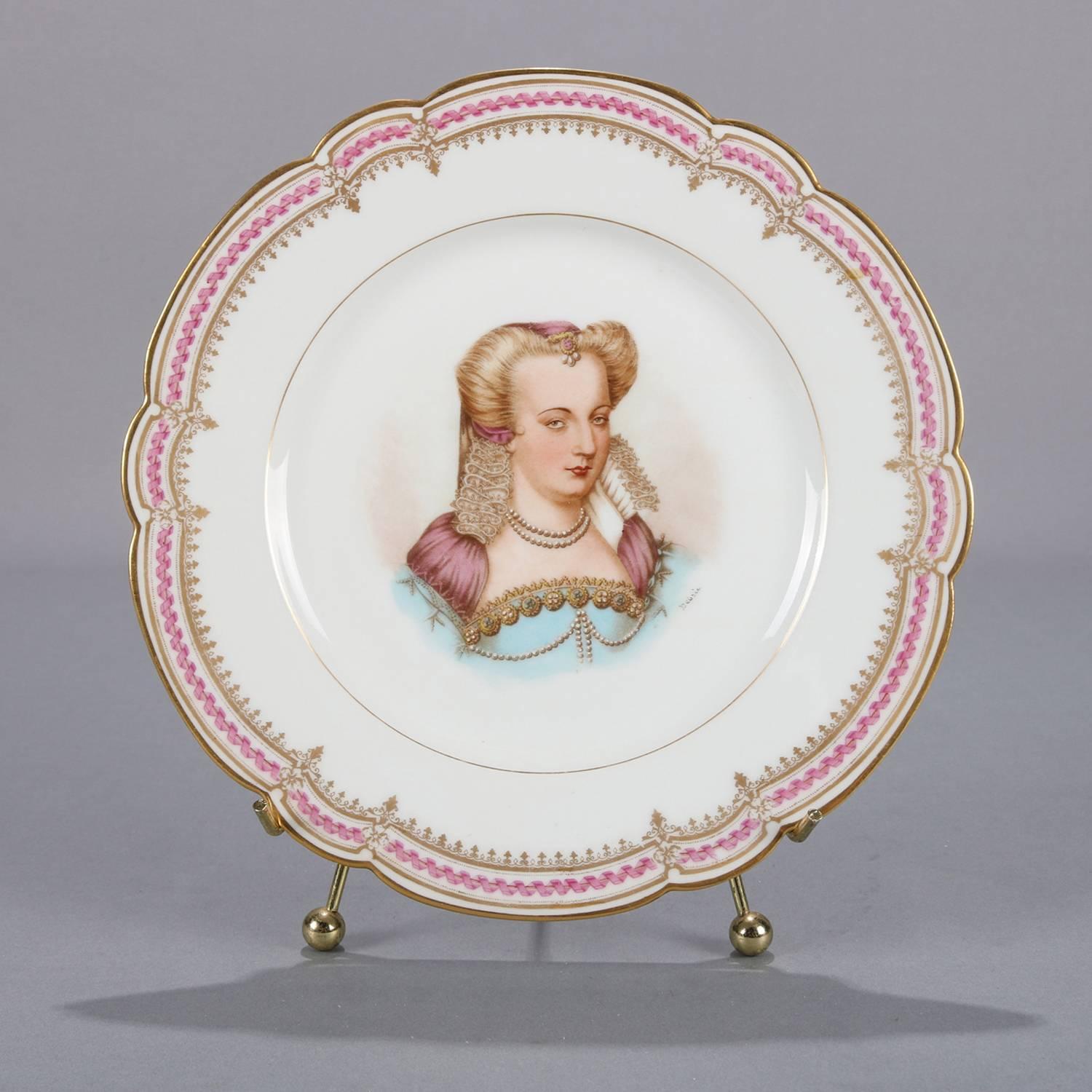 Antique French portrait plate by Sevres for Chateau de St Cloud features well with central artist signed portrait of Louise de Lorraine by Debrie and framed with gilt repeating and stylized fleur-de-lis pattern, rim with gilt scalloped edges and