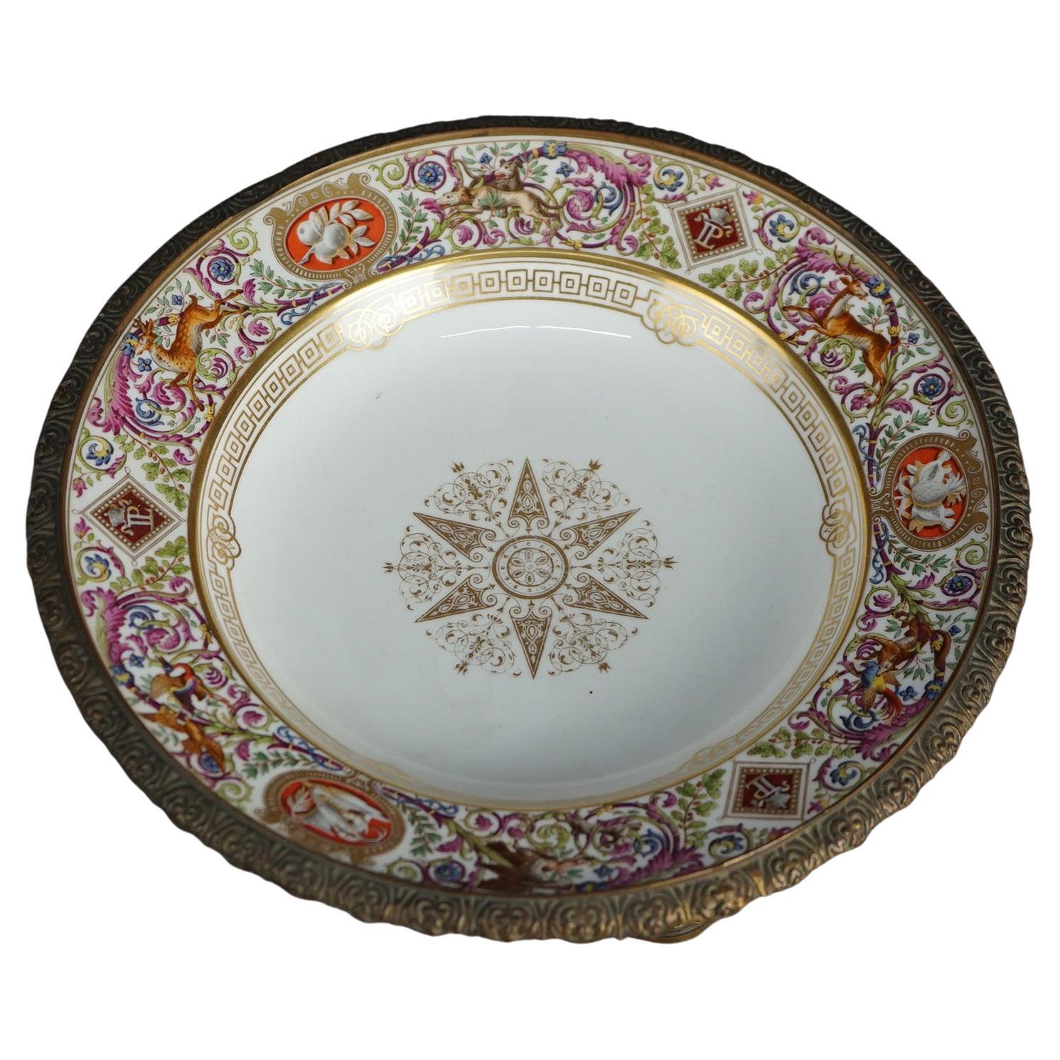 Antique French Sevrés charger offers gilt decorated porcelain plate with deer and foliate elements on garland form gilt cast bronze base, maker mark en verso as photographed, c1890

Measures- 5.5''H x 10''W x 10''D