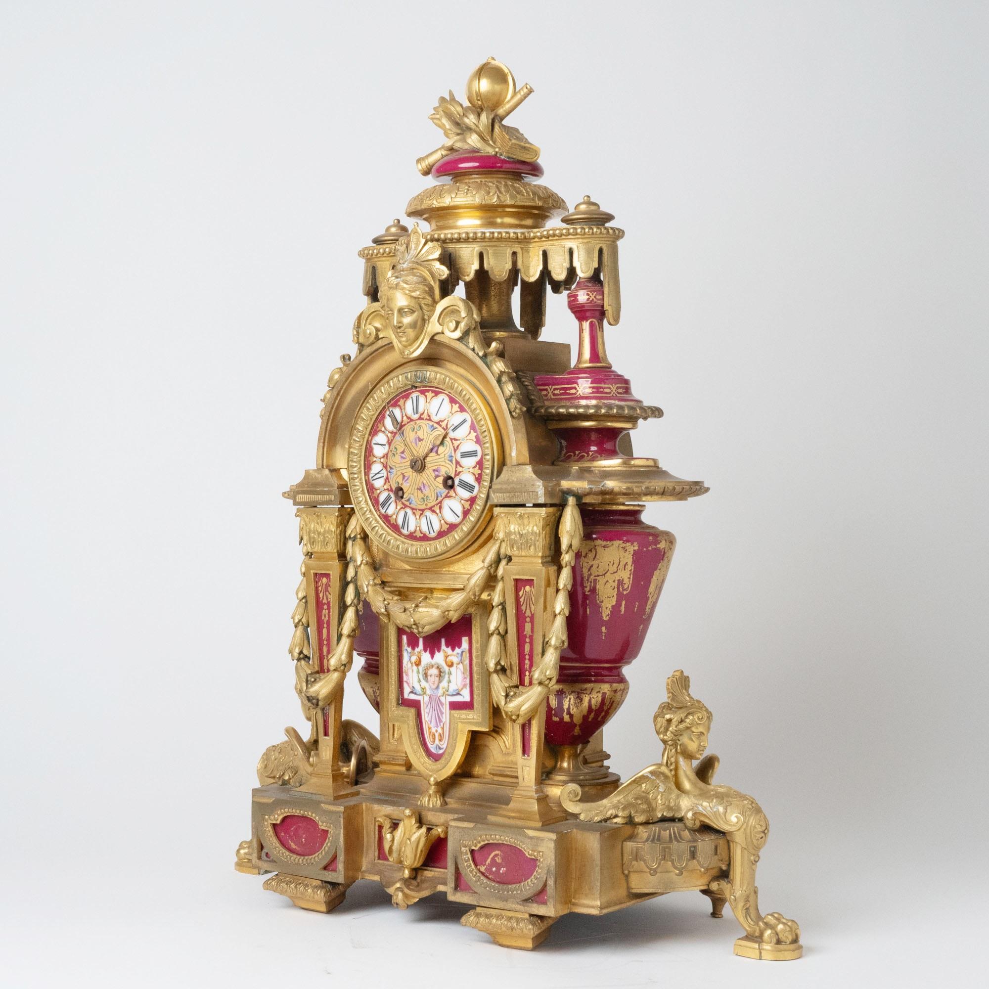 Elegant mid-19th century French mantel clock, finely crafted with gilt-bronze ormolu mounts and exquisite hand-painted Sèvres porcelain panels. The clock is adorned with striking bronze sphinx figures at each side, resting on four bronze paw feet,