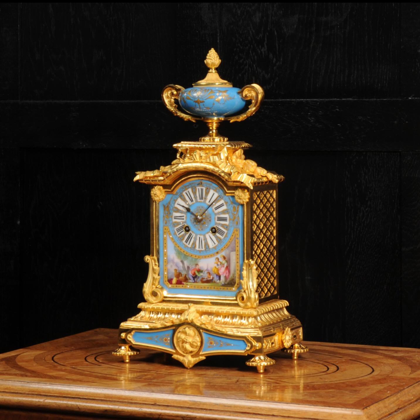 A fine and stunning original antique French boudoir clock. It is beautifully made of ormolu (finely gilded bronze), very well modelled and chased, and mounted with exquisite Serves style porcelain. The ormolu is in stunning, untouched, original