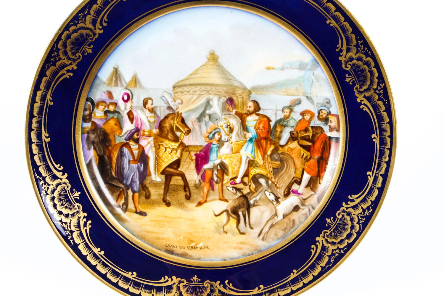 This is a beautiful antique French Sevres porcelain cabinet plate, Circa 1880 in date.
 
It is superbly hand painted plate and features a central panel with a 15th century battle scene within Royal blue borders with decorative gilt scrolls and
