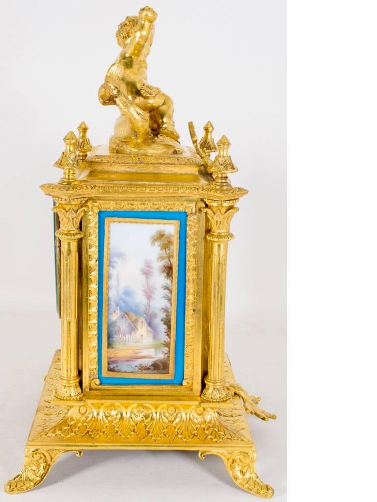 This is a lovely antique French ormolu, gilt bronze, mantel clock with a profusion of Roue blue porcelain panels in the Sèvres manner, circa 1870 in date.

The movement carries the Paris retailers and the clock maker mark HP & Co. and what we