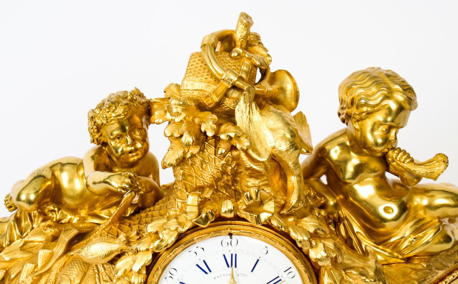 This is a lovely antique French ormolu, gilt bronze, mantel clock with Bleu Celeste Sevres porcelain panels, by the renowned maker, Raingo Freres, Paris, circa 1850 in date.

The clock features a beautifully cast pair of ormolu cherubs surmounted