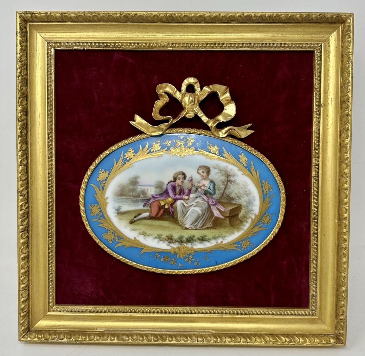 An imposing French Sevres Porcelain Ormolu Mounted hand painted framed miniature plaque of oval form, depicting a romantic scene with a seated lady and a kneeling gentleman offering the lady a bunch of flowers, both dressed in Eighteenth Century