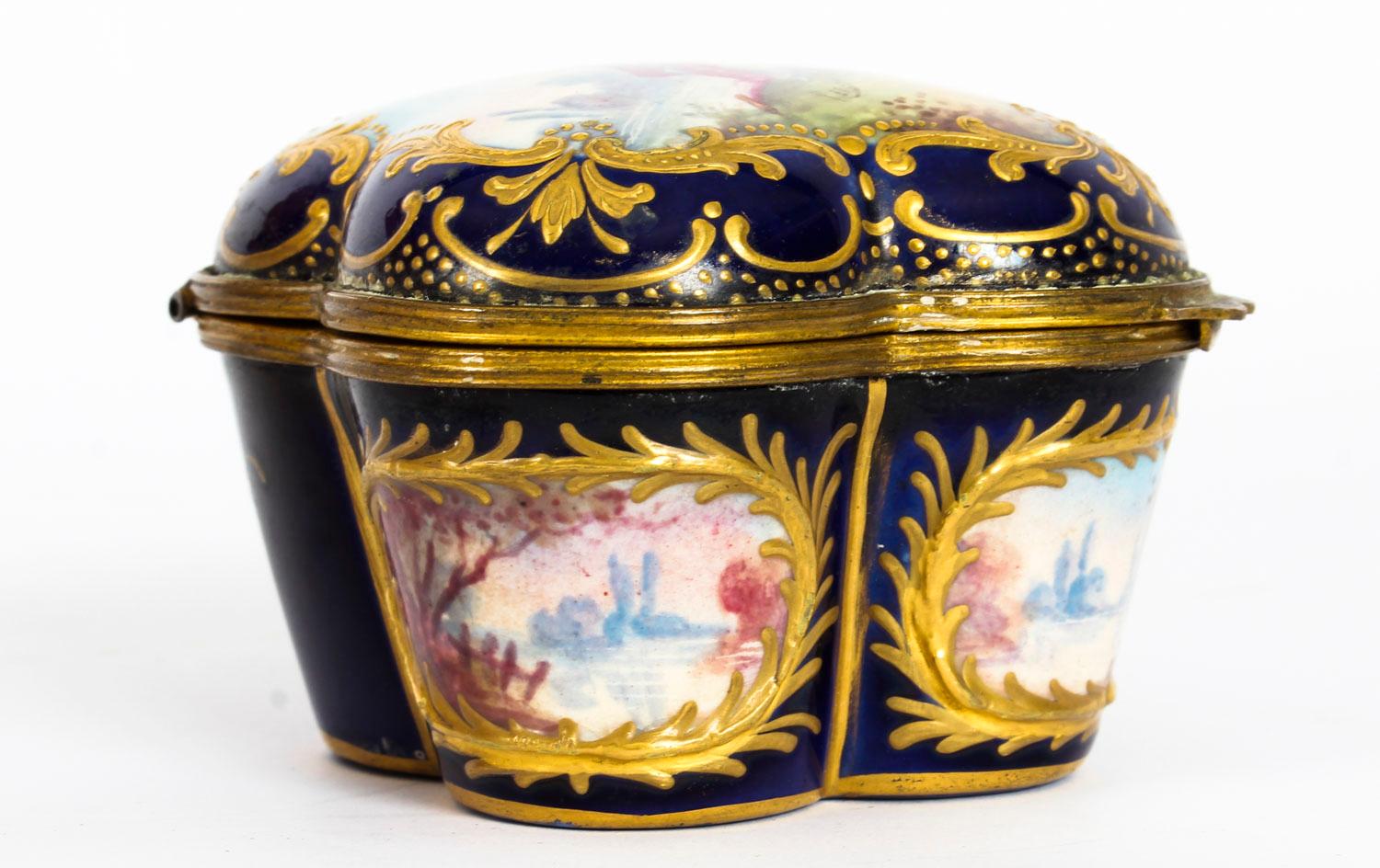This is a fabulous antique French Sèvres Porcelain ormolu-mounted quatrefoil casket, circa 1860 in date.

The shaped hinged cover decorated with a hand painted courting couple in a richly gilded border, the front and sides decorated with oval