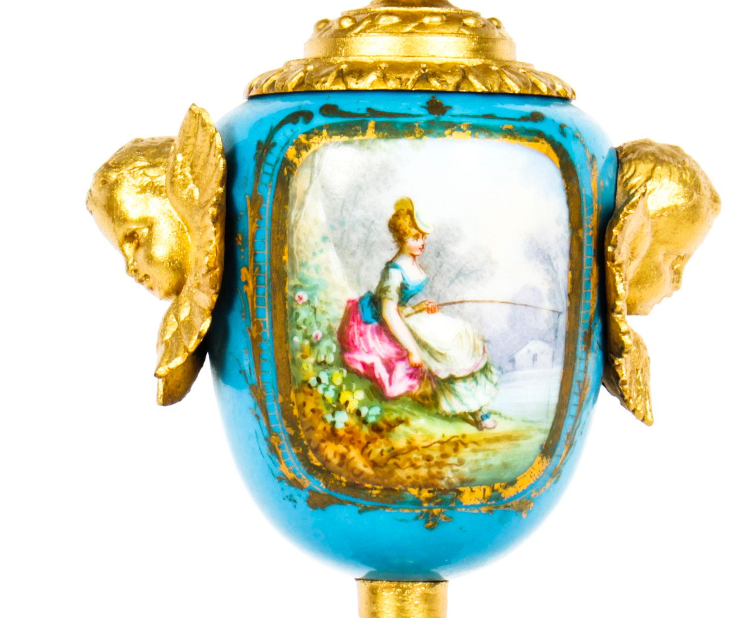 A fine quality French Sevres Porcelain gilded electric table lamp, circa 1870 in date.

The ovoid shaped body features hand painted socle support depicting a gentleman flute player on a celeste blue ground, ending on an ornate base decorated with