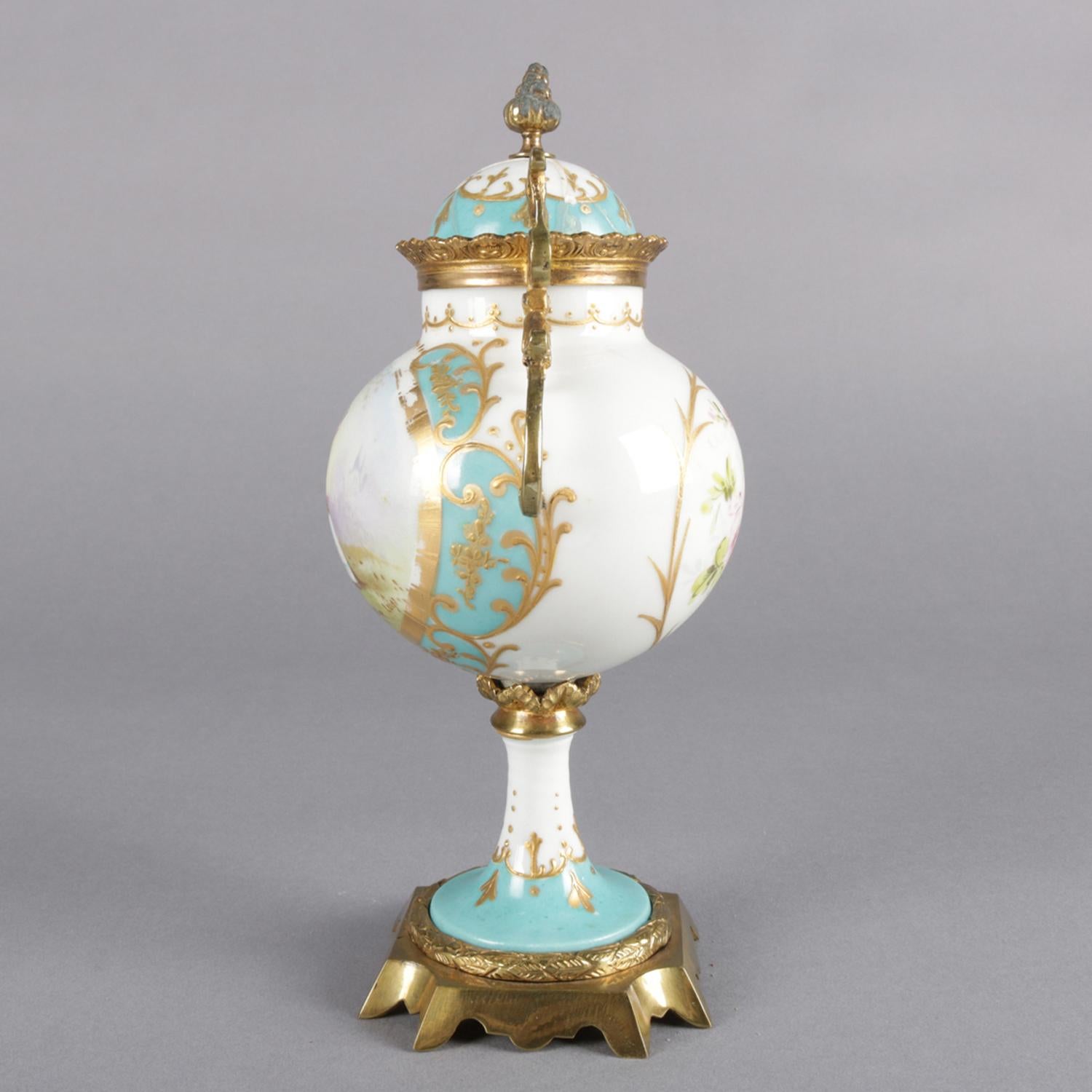 Antique French Sevres school porcelain lidded urn features hand painted reserves of courting scene signed Lugi and en verso floral spray, gilt scroll highlights throughout and with bronze attachments, 19th century

Measures: 9
