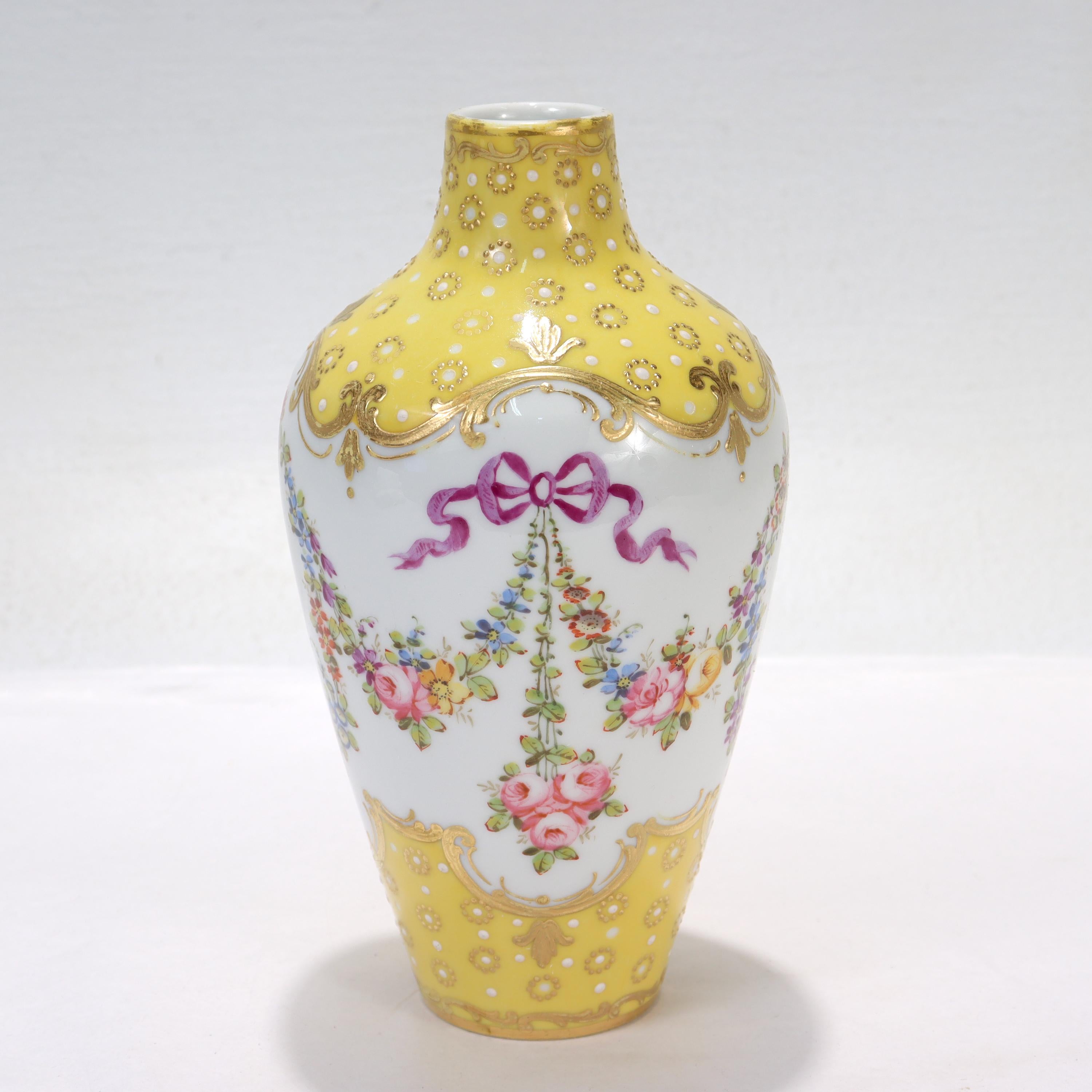 A fine antique French Sevres type porcelain vase.

With gilt highlights on a yellow ground, hand painted floral garlands, and white enamel jeweling throughout. 

Simply a wonderful antique French porcelain vase!

Date:
Late 19th or Early 20th