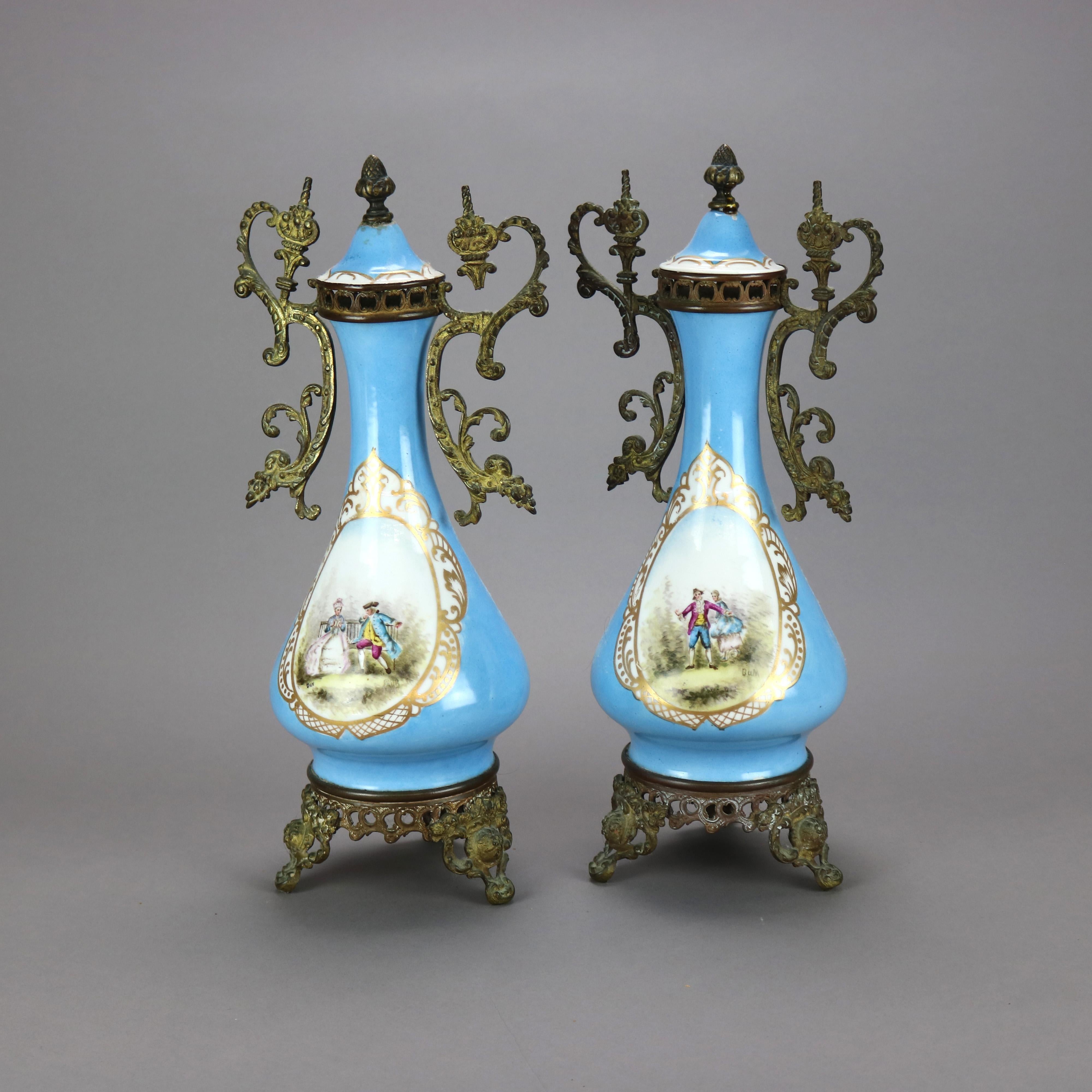 An antique pair of French Sevres covered urns offer porcelain construction with reserves having hand painted courting scenes with gilt trimming, foliate cast ormolu mounts, and signed with maker on lid as photographed, c1890

Measures - 16.75'' H