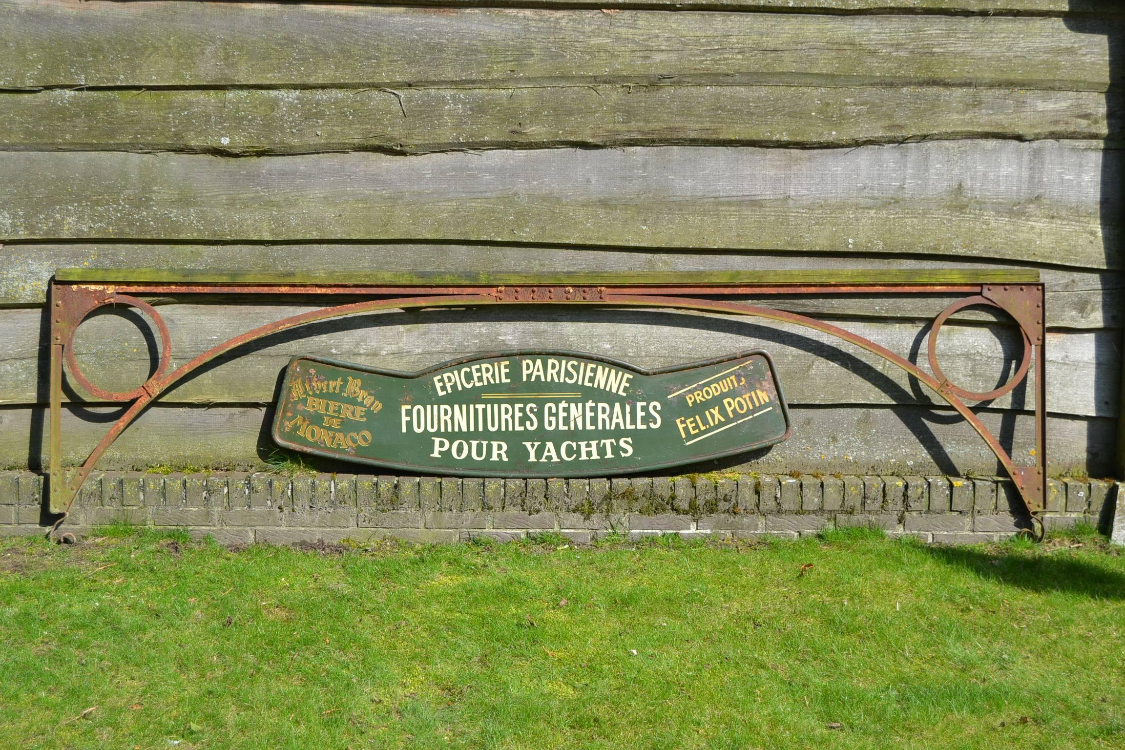 Antique French Shop Sign from Paris.
This shop sold supplies and provision for boats - yachts. 
Has a lot of charme due the signs of age. 
Dates from the Art Deco Period , circa 1920 - 1930.
Green painted iron billboard with white and yellow