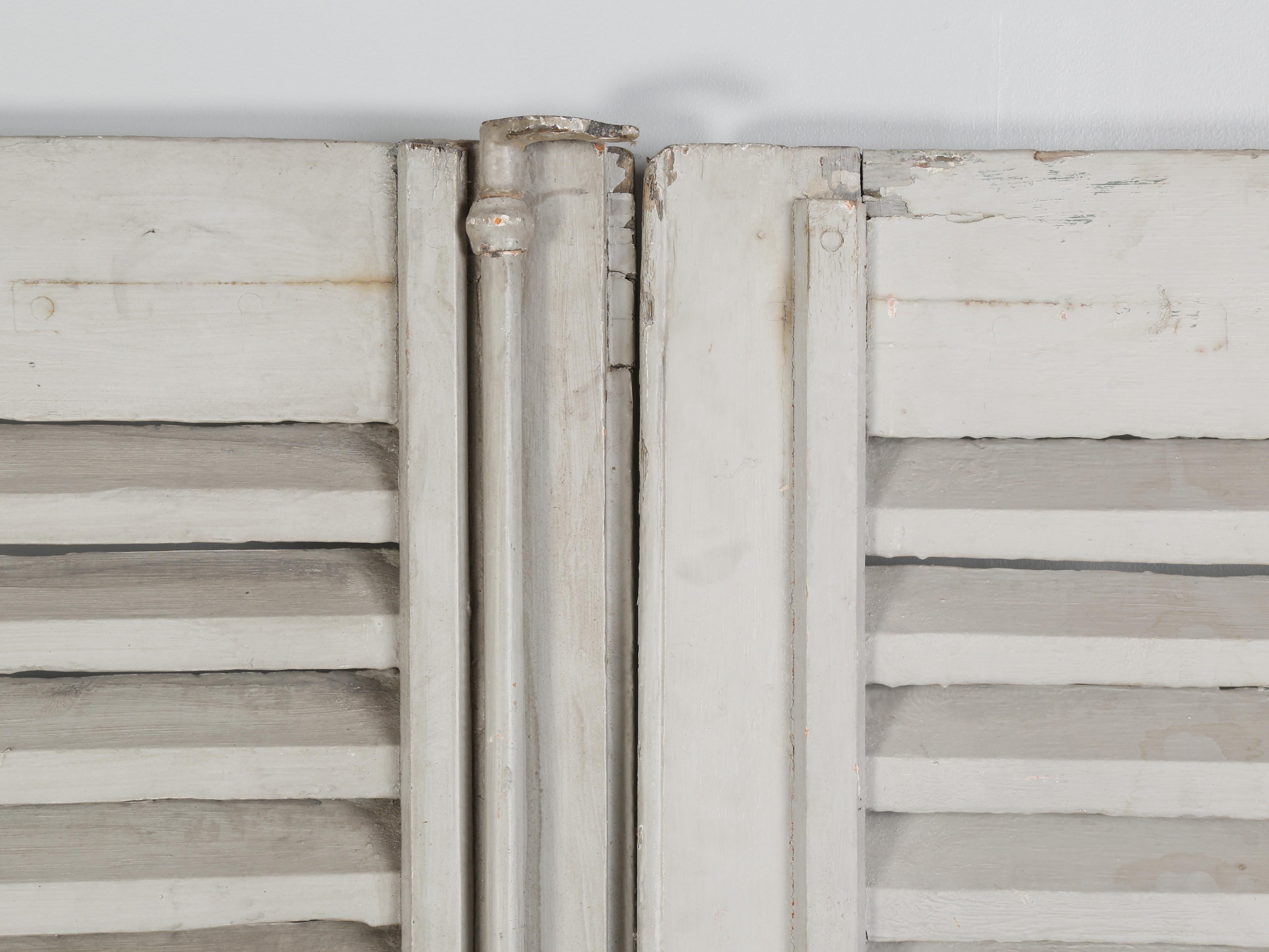 Antique 18th century French Shutters in old putty grey paint. In total, we currently have a grouping of (14) individual shutters, or (7) pairs. The antique French shutters came from a chateau outside of Perpignan in Southwest France, which has a