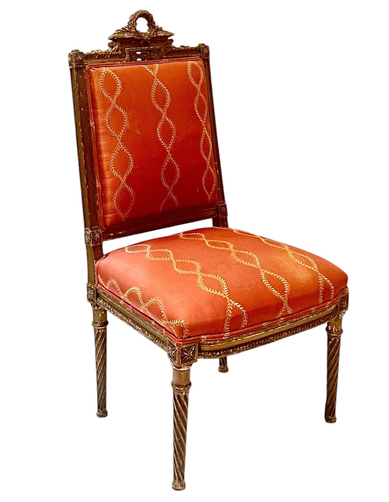 This beautifully carved French chair has a wreath with a bow and other carved elements. The fabric on the chair is an embroidered silk not original. Great condition for its age, but has a lot of patina that we love! Early 19th century, France.