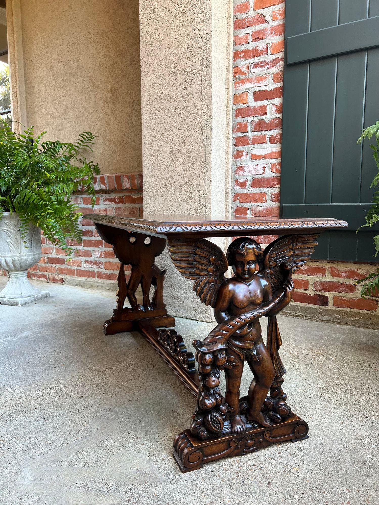 Antique French Side Coffee Sofa Table Carved Walnut Renaissance Cherub c1930.

Direct from France, a beautiful carved French side or coffee table with a lovely silhouette and outstanding carvings on each end. The gorgeous side panels have carved