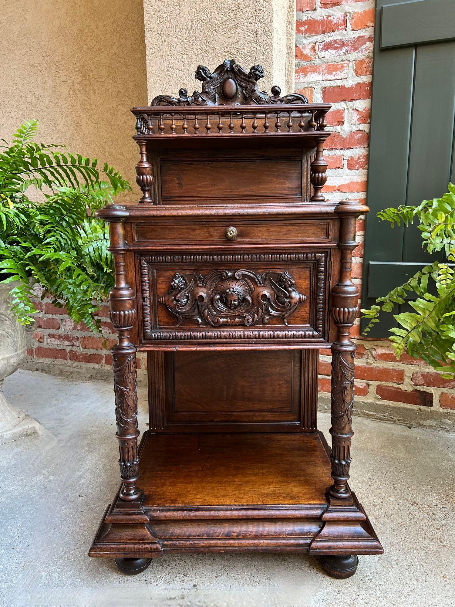 Antique French Side End Table Cabinet Carved Oak Renaissance Spindle Gallery.

Direct from France, a beautiful antique side or end table in a versatile small size, with elegant features!
A gorgeous carved crown with center cartouche rests high above