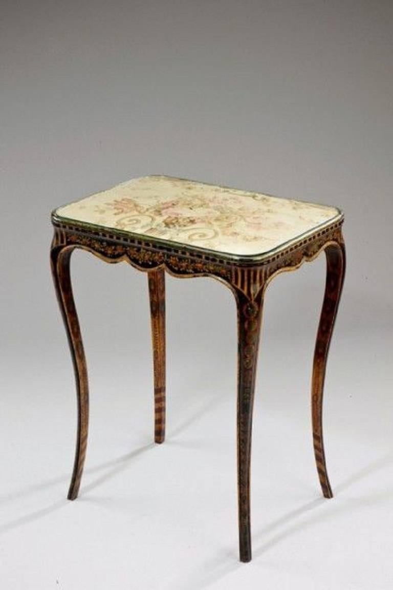 An unusual French side table with the original painted decoration of florals swags on a dark ground. The top with a tapestry panel.