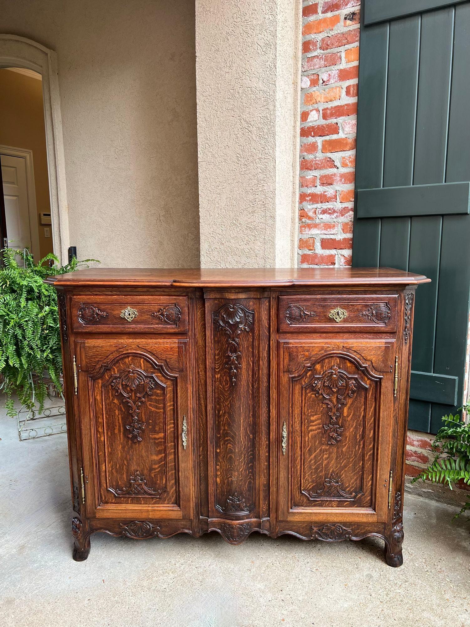 Antique French Sideboard Foyer Cabinet Louis XV Carved Tiger Oak 19th century.

Direct from France, a highly carved antique sideboard or chest with exquisite French style.
Carved fronts to the two drawers and two doors with carvings on the