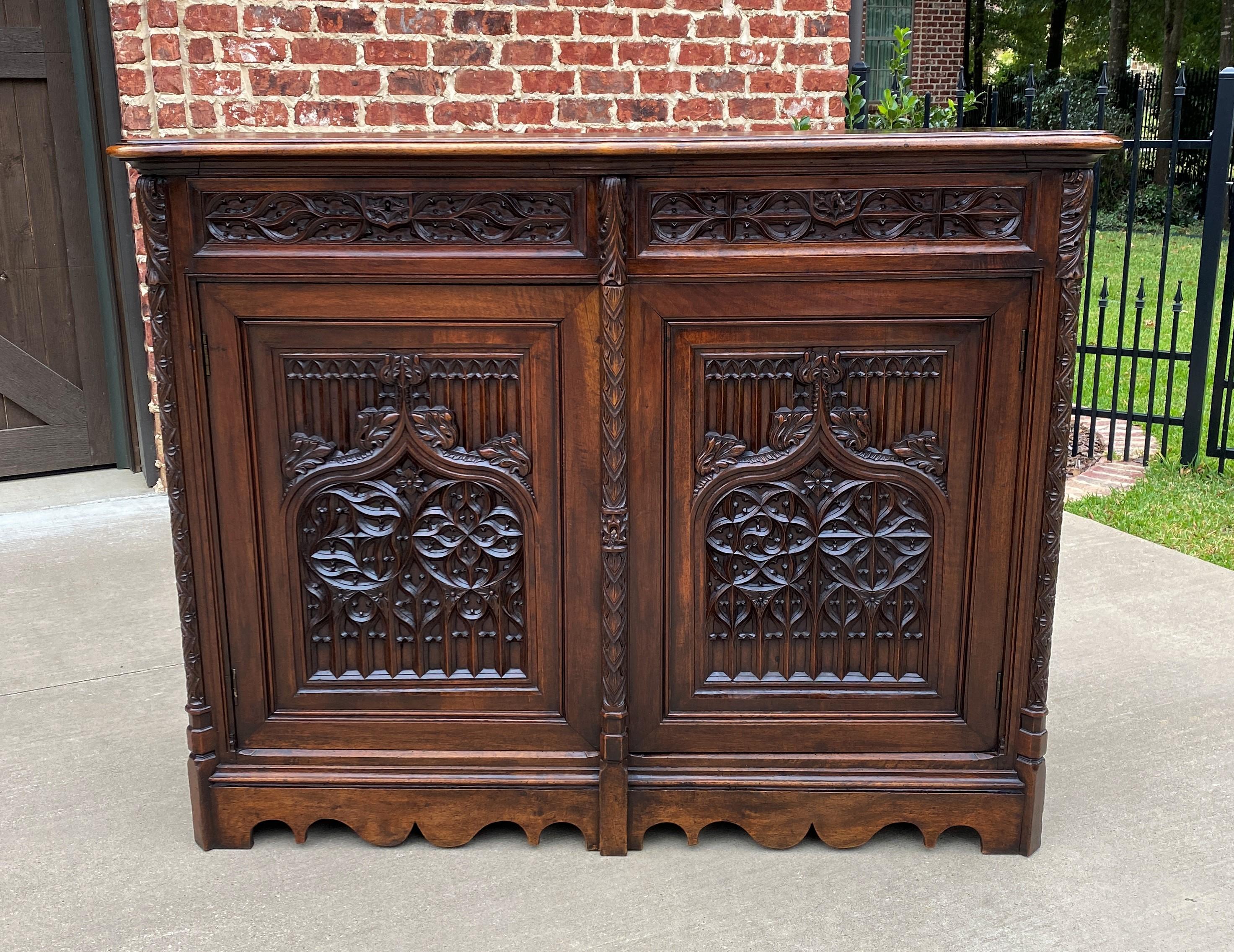 Antique French Walnut Gothic Revival Server Sideboard Buffet cabinet~~c. 1880s 

Beautifully carved throughout~~classic Gothic Revival linen fold sides with thick tracery center door panels~~two hand-cut, dovetailed drawers~~two original keys