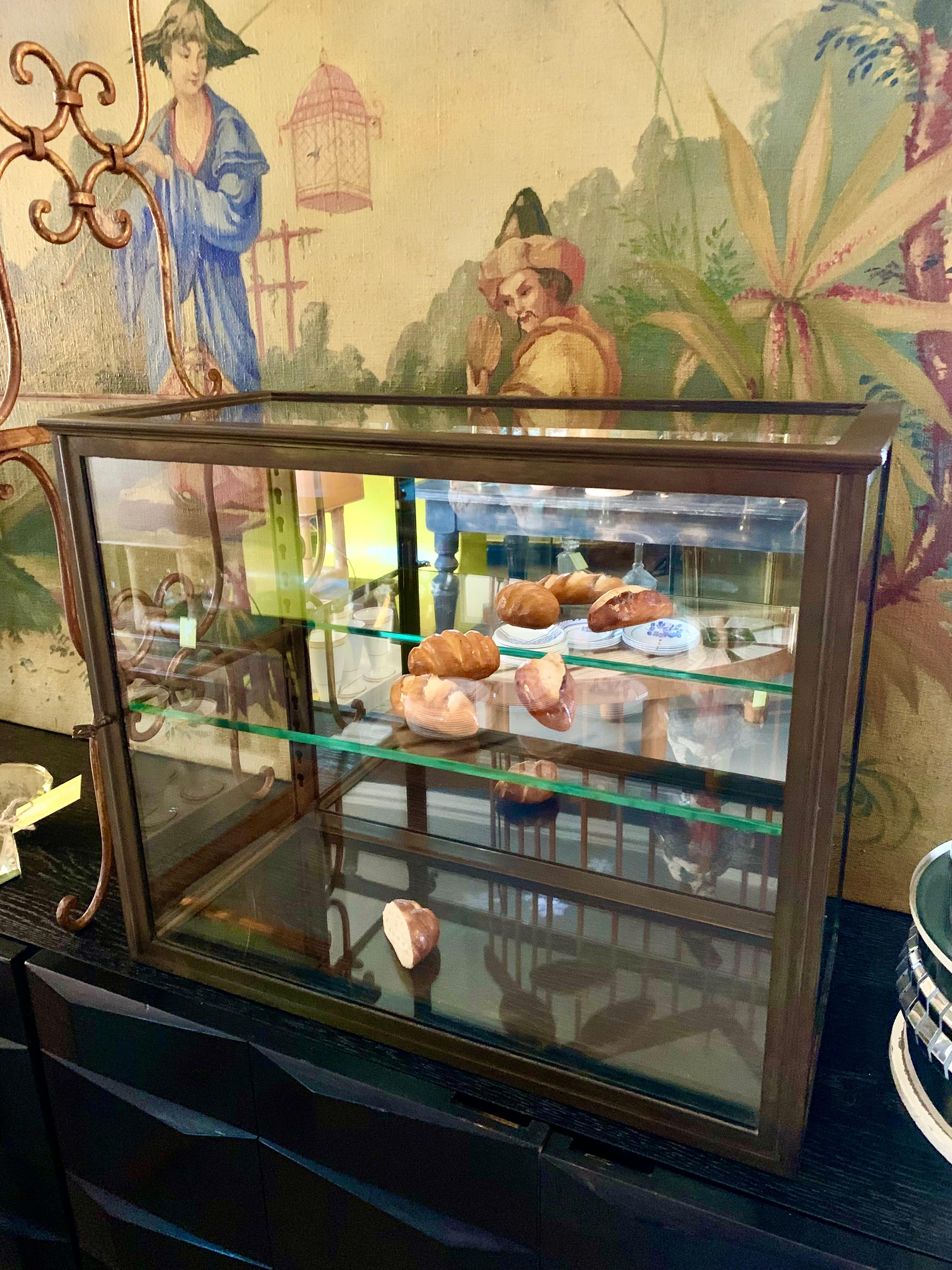 Beautiful antique French brass table vitrine with the most lovely patina. The display cabinet is from renowned manufacturer Siegel of Paris and has 1 adjustable glass shelf. Comes with key! 