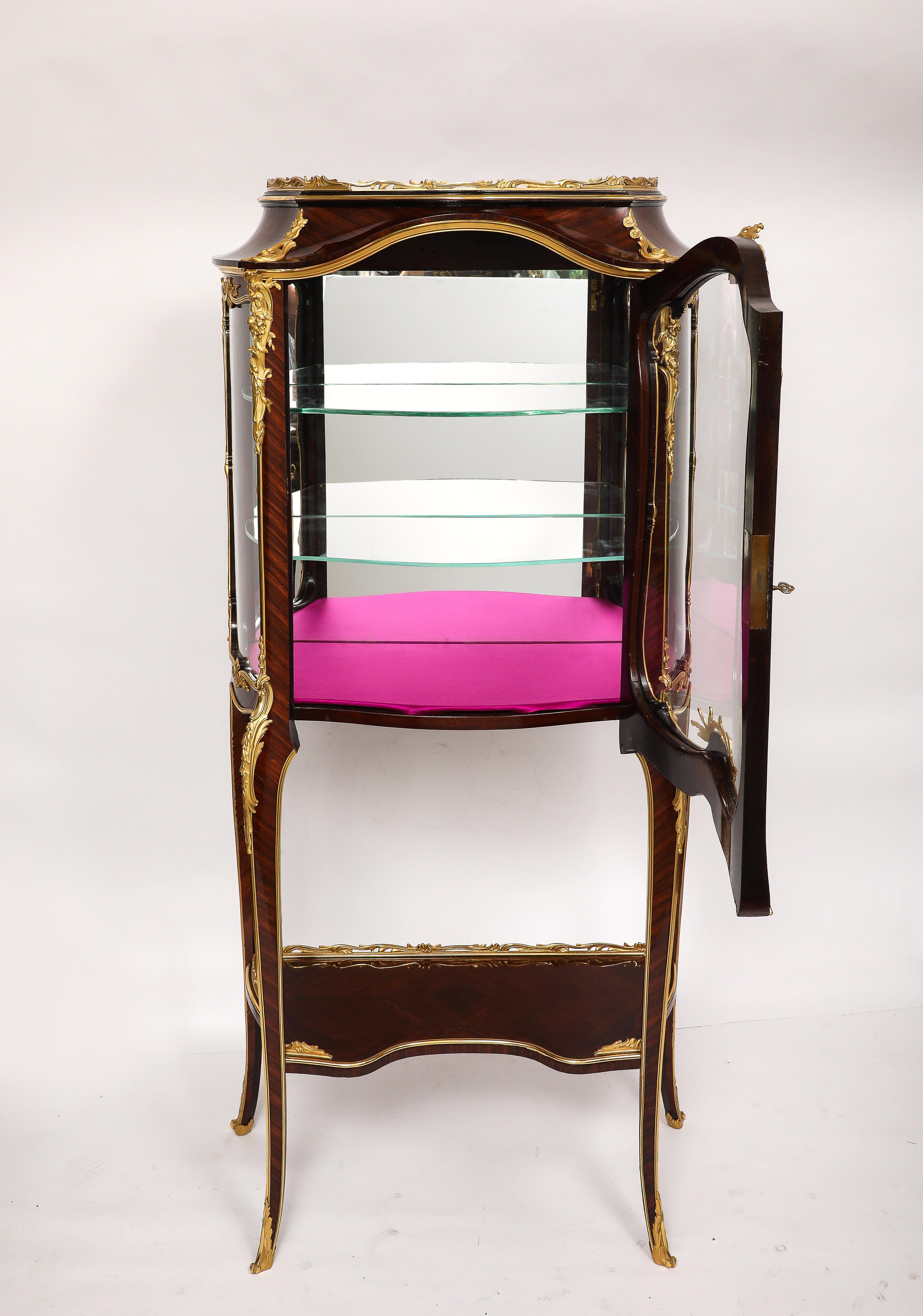 An exceptional and architecturally refined antique French vitrine, signed F. Linke, dating from the late 19th to early 20th century, masterfully constructed  and mounted in exquisitely cast and chased gilt bronze. This vitrine is a striking example