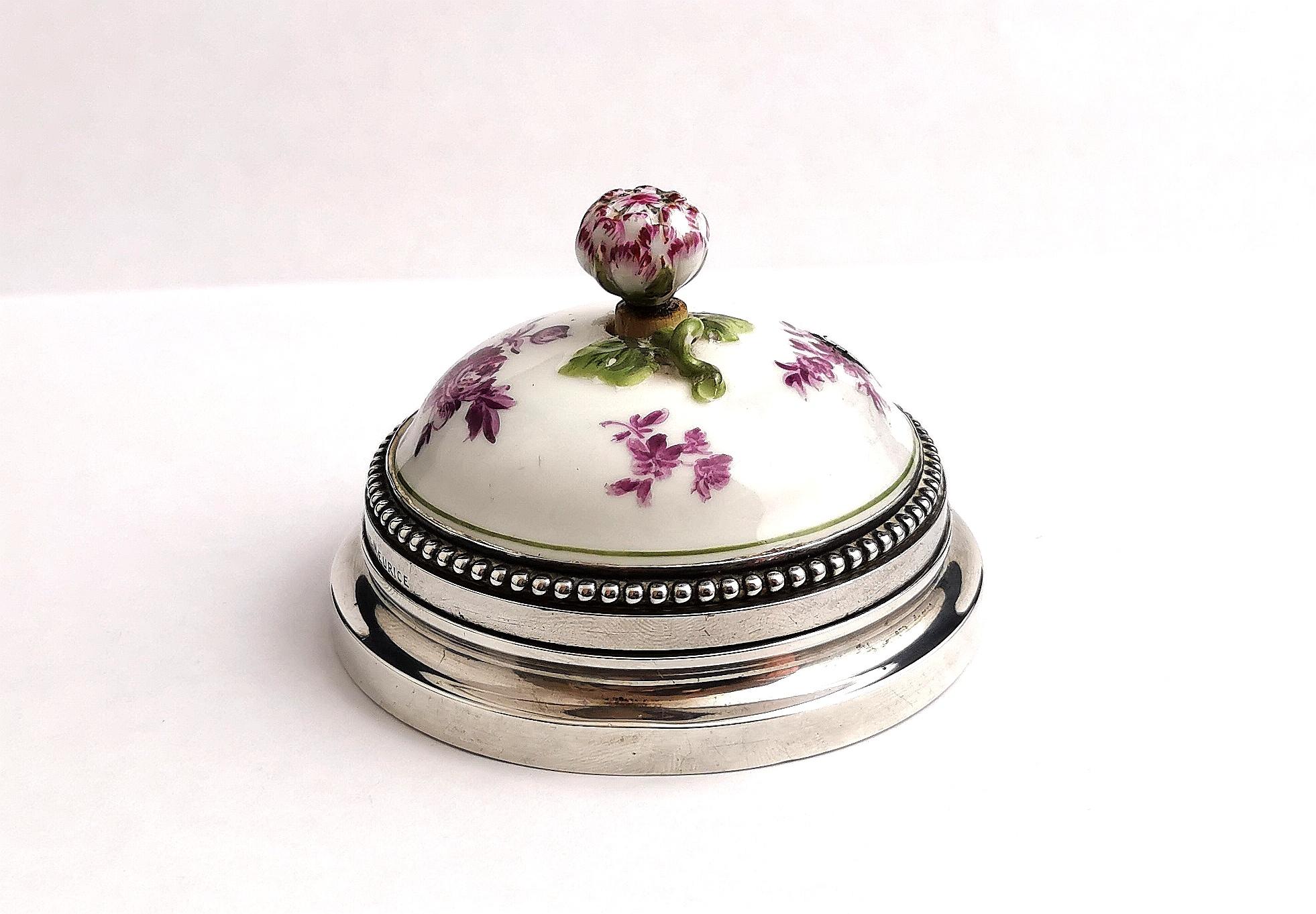 A beautiful, rare vintage Silver and Ceramic door bell push.

This gorgeous piece is made from silver with a ceramic body, the push shaped like a flower bud, the ceramic body delicately decorated with floral designs and a butterfly in a mauve