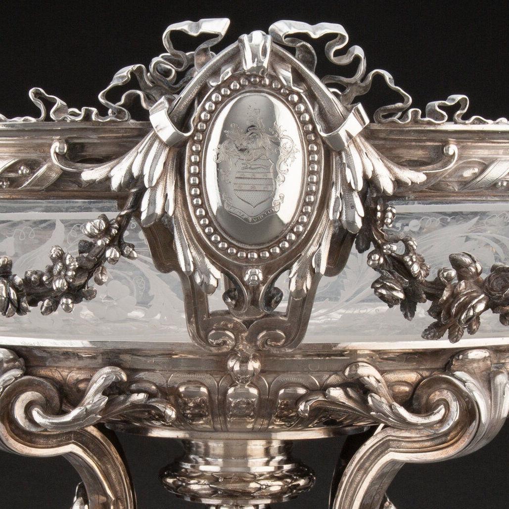 Our magnificent silver centerpiece with its original acid-etched glass bowl comes from Alexandre-Auguste Turquet of Paris, active 1855-1882.  14 3/4 by 22 by 13 in, 37.5 by 55.9 by 33 cm.  8,890 g, 313.59 oz.

This oval shaped piece has two