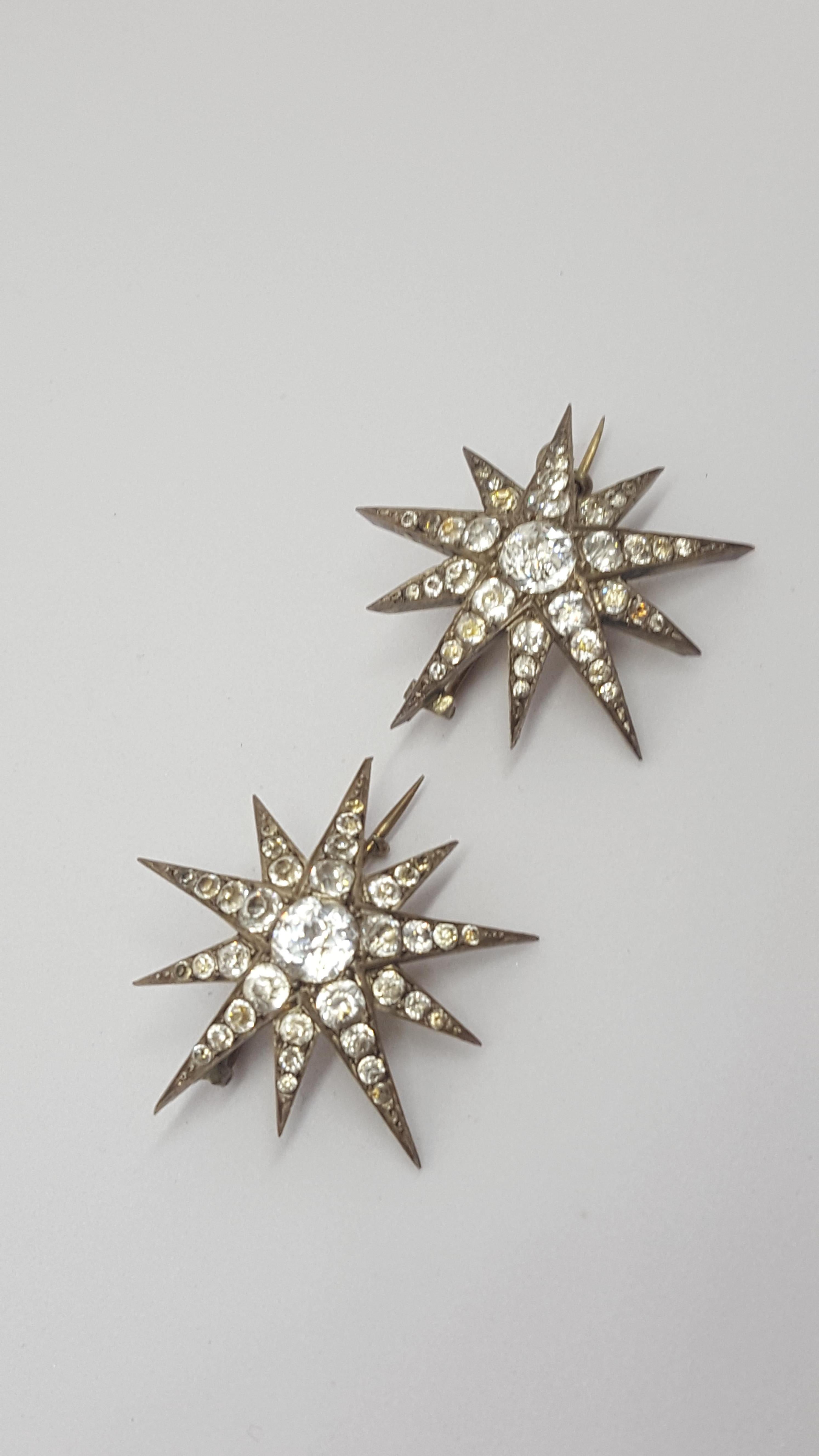 A pair of Gorgeous Antique c.1900 French origin Silver and cushion cut Paste Star brooches. The brooches also can be worn as a hair ornament.
Width 35mm each. 
One brooch marked on c-catch with French mark for Silver. 
Both brooches complete with