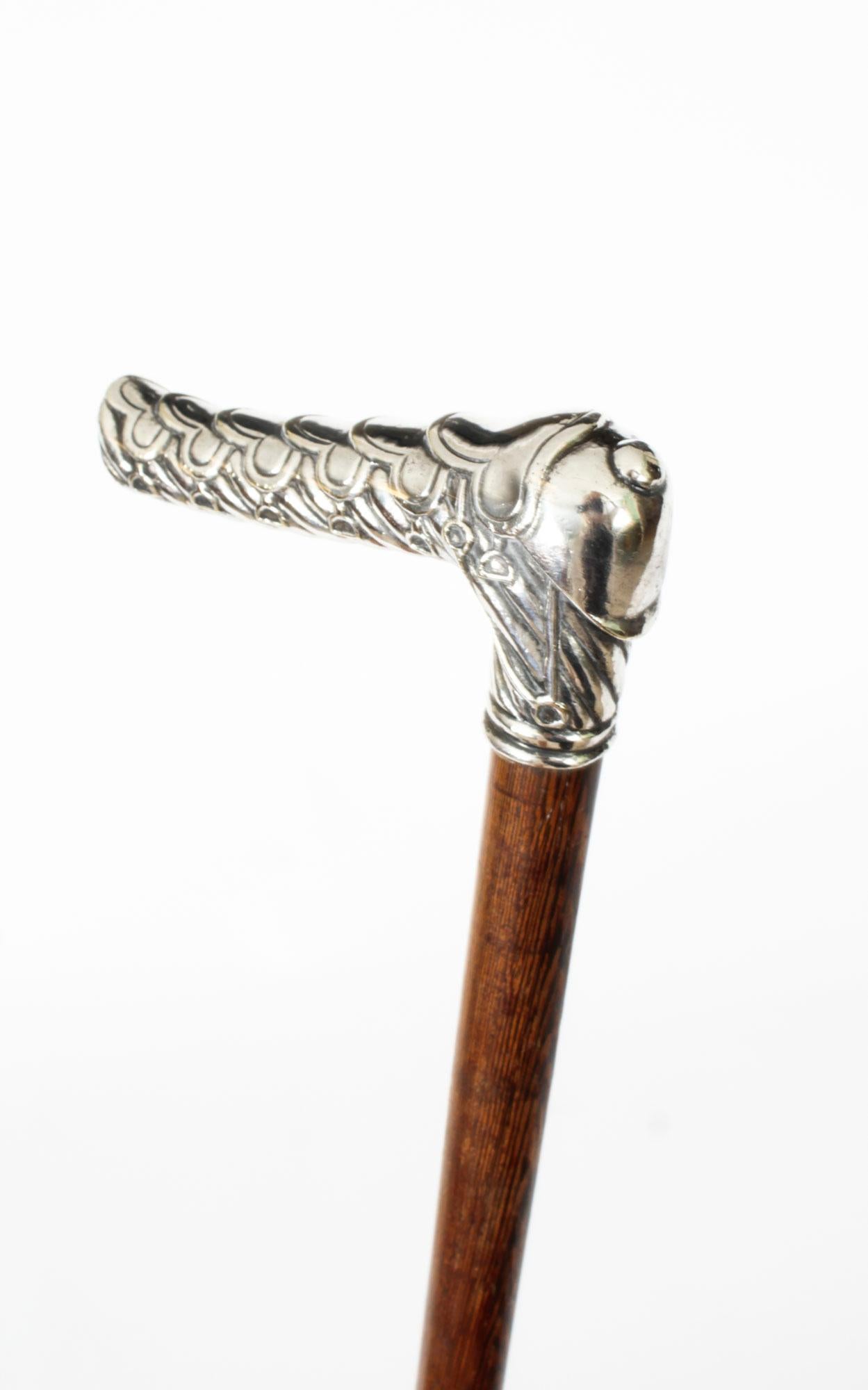 This is a truly magnificent and rare antique French sterling silver mounted walking cane, Circa 1880 in date.
 
This superb decorative walking cane has a splendid chased silver handle in the form of a capped saddle and stirrup design. It has been
