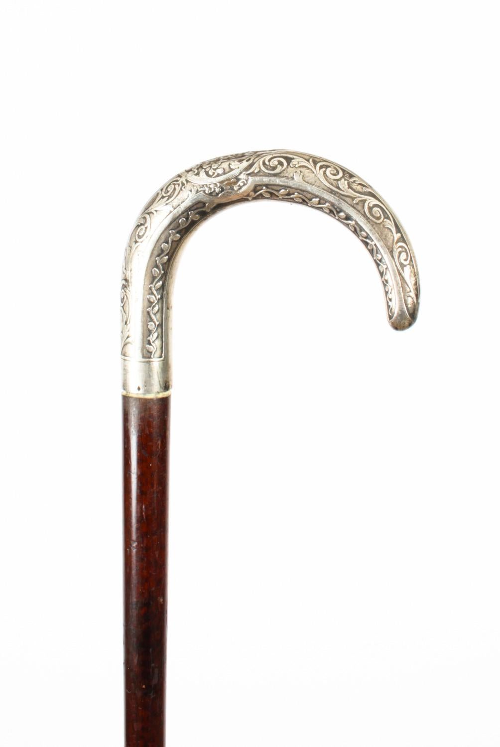 This is a fantastic antique French silver handled and mahogany walking stick, circa 1880 in date.

It has a very decorative silver hook handle decorated with foliate ornamentation which is cast with great attention to detail with a sturdy mahogany