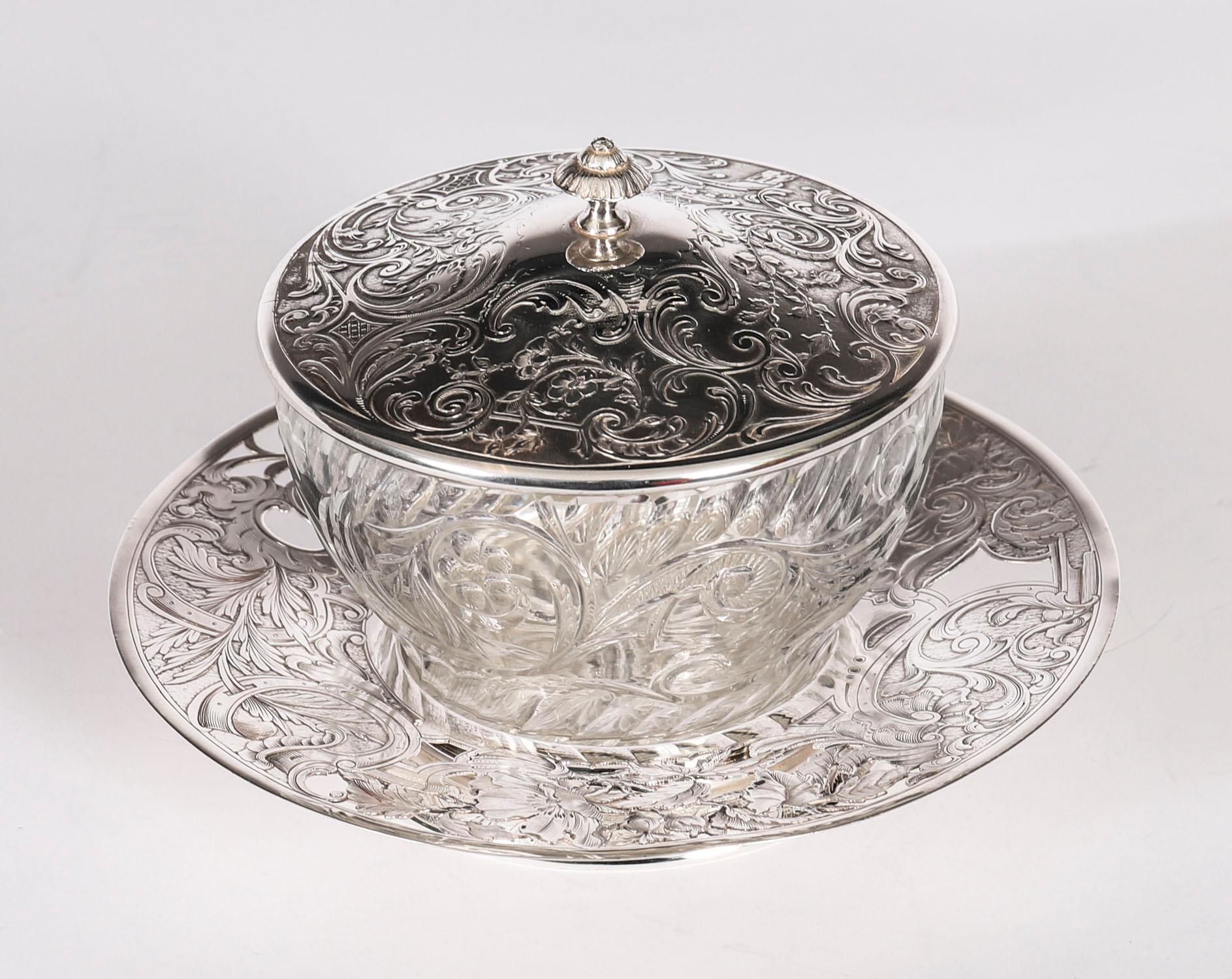 Si tratta di un favoloso piatto da burro francese in argento e cristallo tagliato con coperchio a cupola e supporto, datato circa 1880.

Il piatto da burro rotondo presenta un coperchio a cupola sollevabile decorato con fogliame inciso e in rilievo