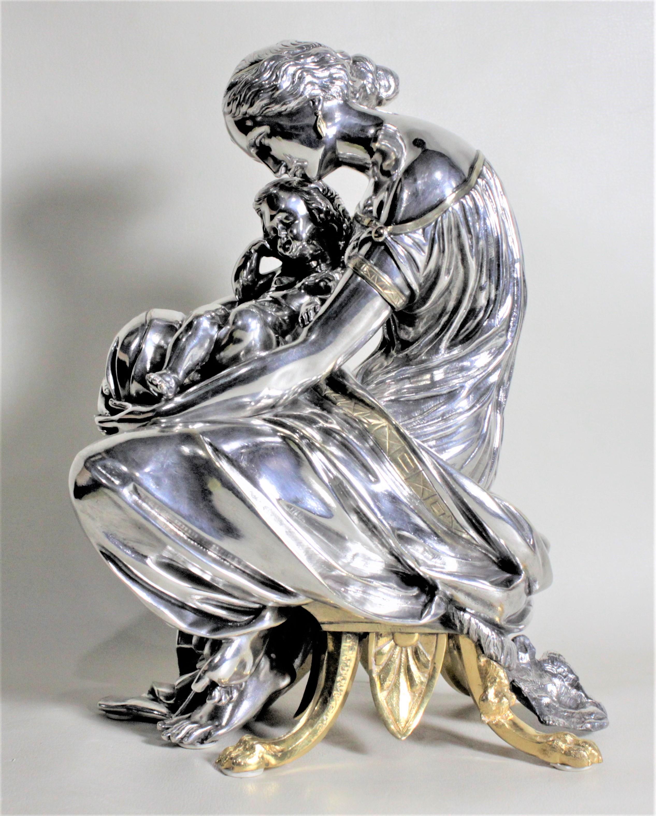 This well executed bronze sculpture depicting a mother seated holding her baby was presumed to have been made in France in circa 1900. This bronze has been heavily silvered giving it an almost chromed appearance with additional gilt accenting to the