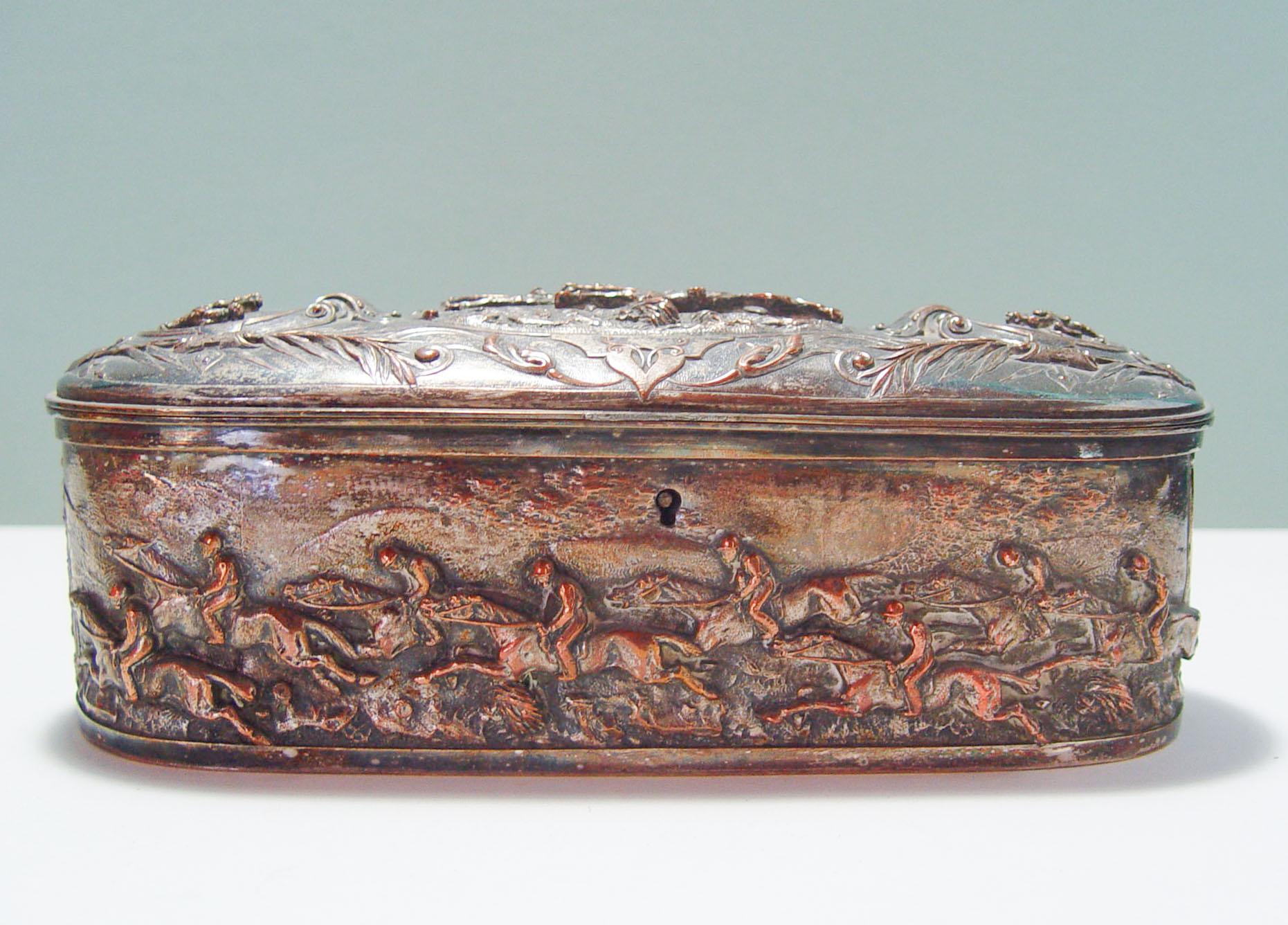 Antique french silver plate over copper jewelry casket with very high relief horse racing equine motif all around, circa 1890's. Interior is tufted purple silk, had feet at one time, since removed. Marked with B and Clover on bottom. French silver