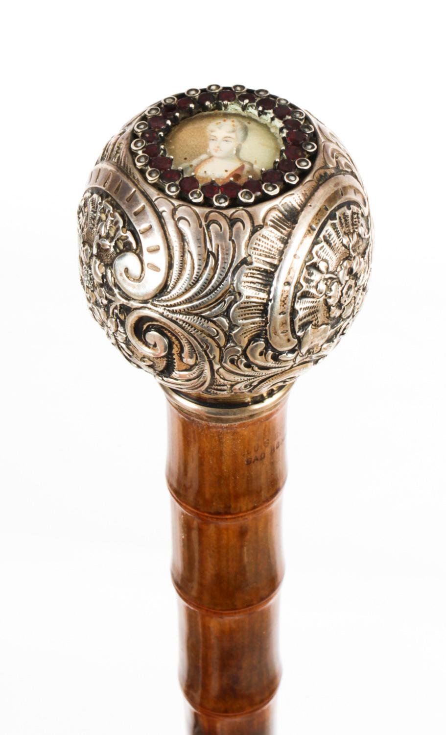 This is a fantastic antique French silver and bamboo walking stick, circa 1880 in date.

It has a very decorative silver pommel which is inset with a glazed portrait within a surround of garnets  with an extra long sturdy bamboo tapering shaft which