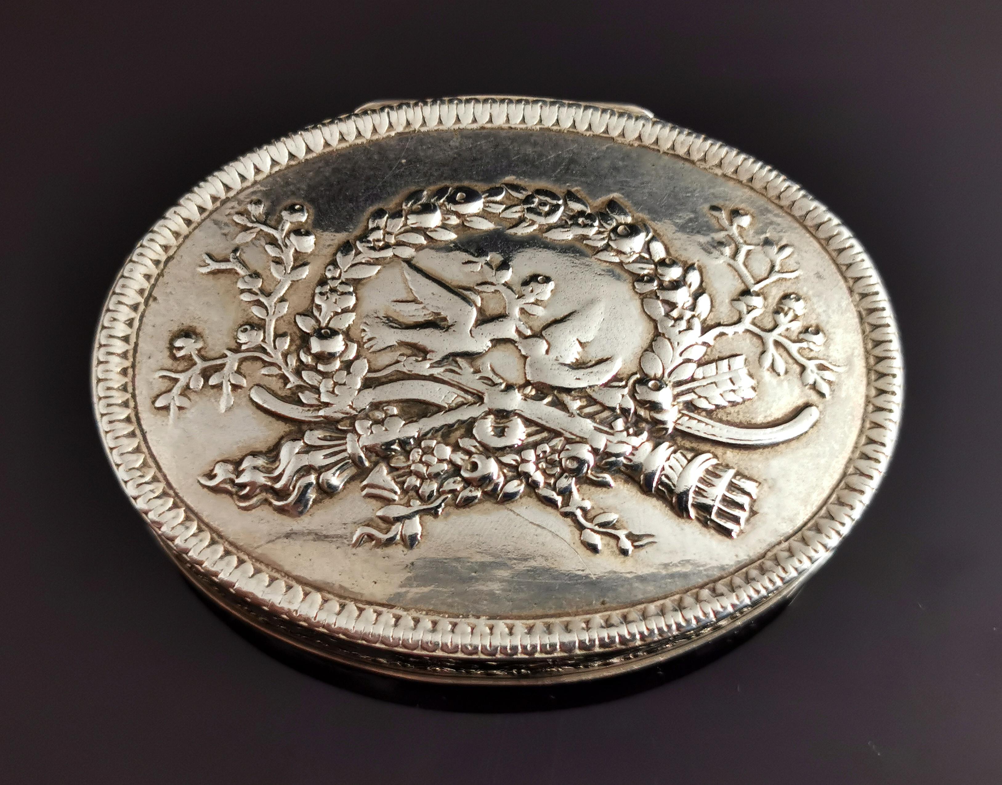 A fine antique French silver snuff box.

A table snuff box this is heavily and expertly decorated with bows, swags and flowers around the sides, a light pie crust rim and the image on the lid of two peace doves with an olive branch.

A lovely