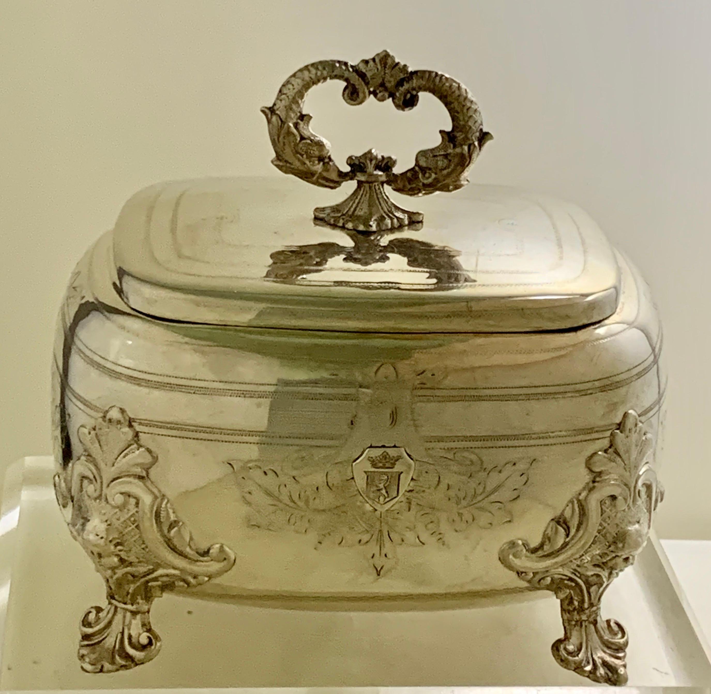Ornate antique French sterling silver sugar casket, lidded sugar box,
A high quality piece with double fish finial, engraved decoration, ornate feet
with a coat of arms at the front.
Presented in very good condition and well cherished.