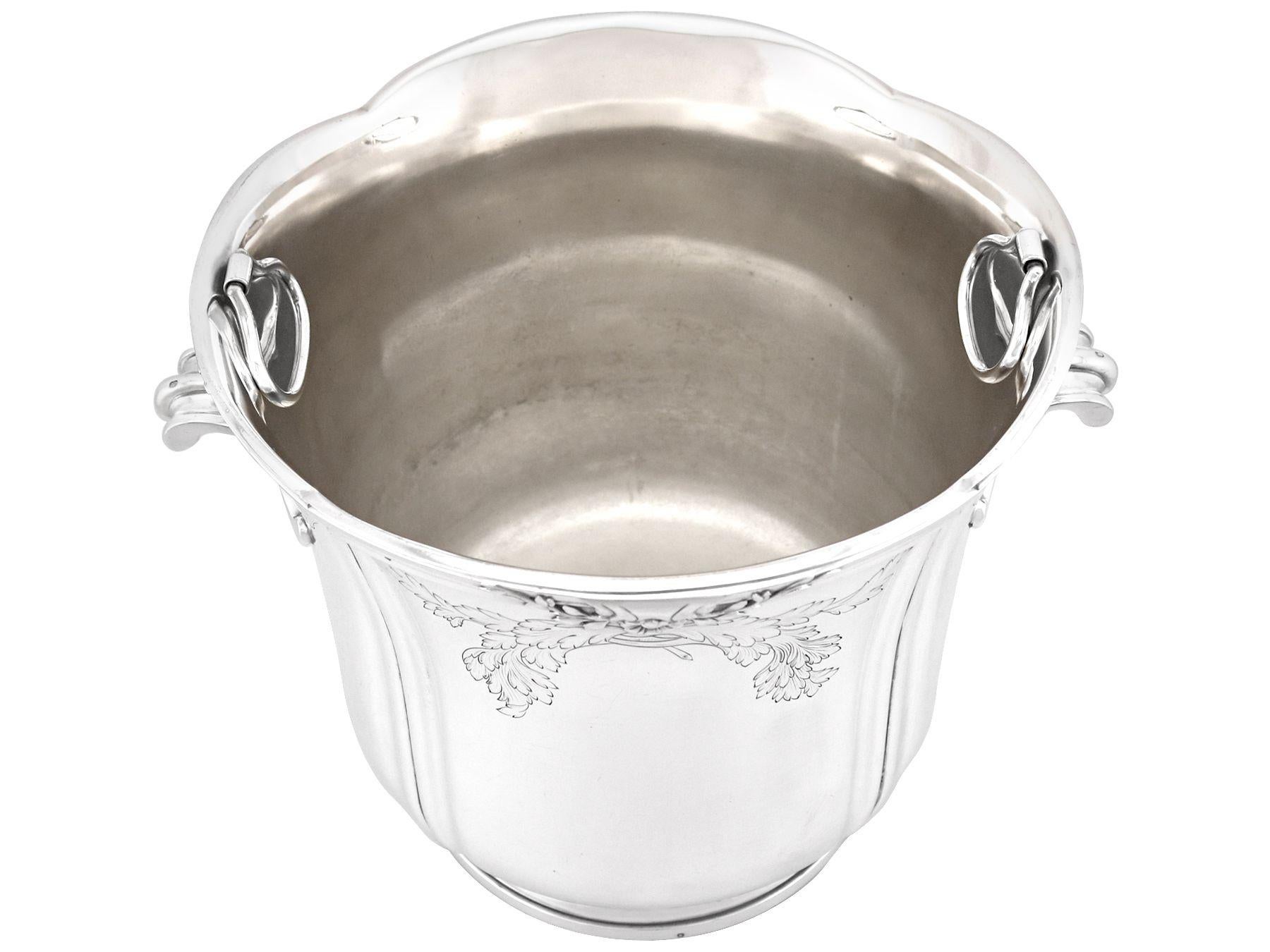 An exceptional, fine and impressive antique French silver wine/champagne cooler; an addition to our presentation silverware collection.

This exceptional antique French silver wine cooler has a circular rounded form.

The panelled surface of this