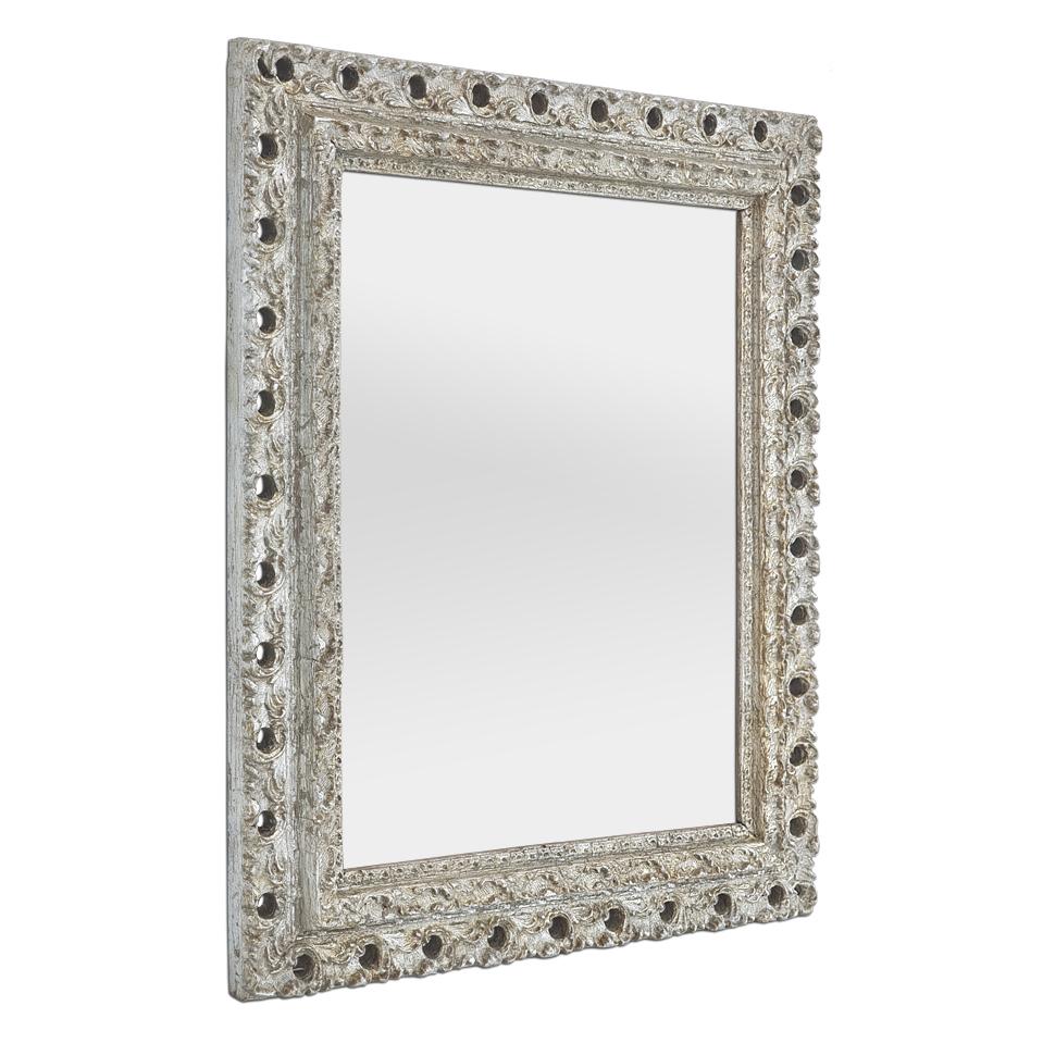 Antique French wall mirror, in patinated silvered wood, circa 1900, orned with stylized foliage decoration. Leaf gilding. Frame width: 7.5 cm / 2.95 in. Modern glass mirror. Wooden rear panel.