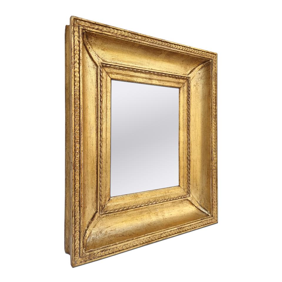Antique giltwood wall mirror, Louis-Philippe French style, circa 1850. Antique frame adorned with twists and piastres, spandrels in the corners. Re-gilding to the leaf patinated (Antique frame width measures: 9.5cm / 3.74 in.). Modern glass mirror.