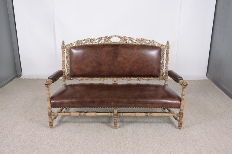 This extraordinary antique french hand carved sofa is in great condition and has been professionally restored by our expert craftsmen team. This eye-catching piece is beautifully crafted out of solid oak wood newly bleached this antique sofa